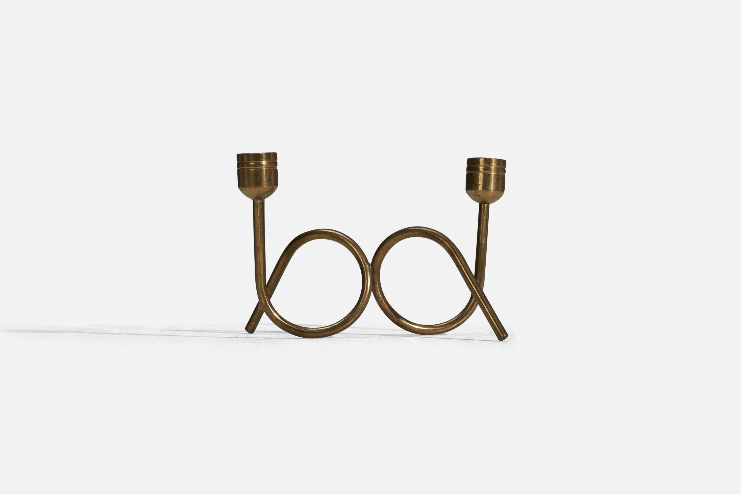 A pair of brass candle holders designed and produced in Denmark, 1940s.