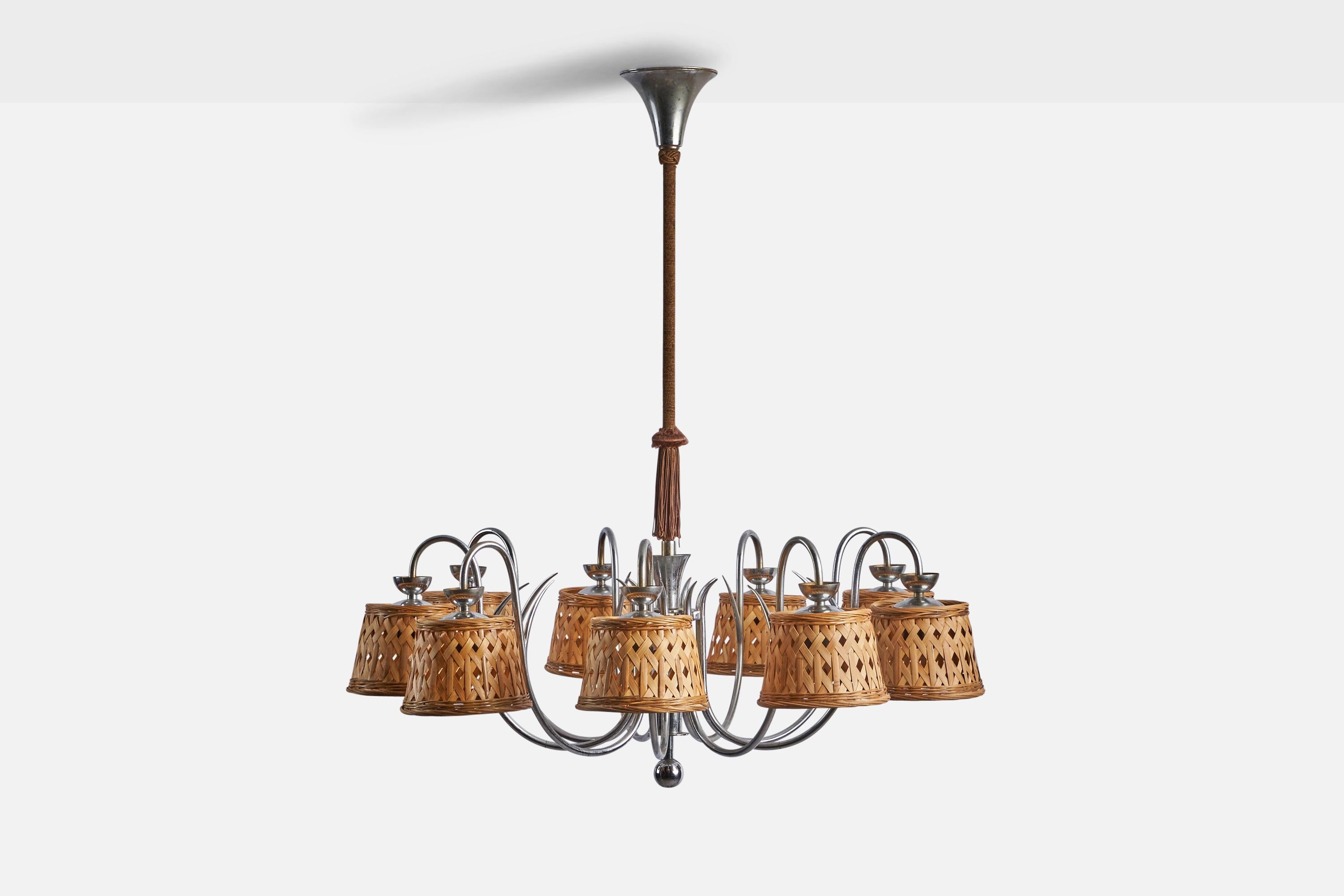 A sizeable nine-armed steel, brown fabric cord and rattan chandelier designed and produced in Denmark, c. 1930s.

Overall Dimensions (inches): 39” H x 31” Diameter
Bulb Specifications: E-26 Bulb
Number of Sockets: 9
Assorted vintage rattan