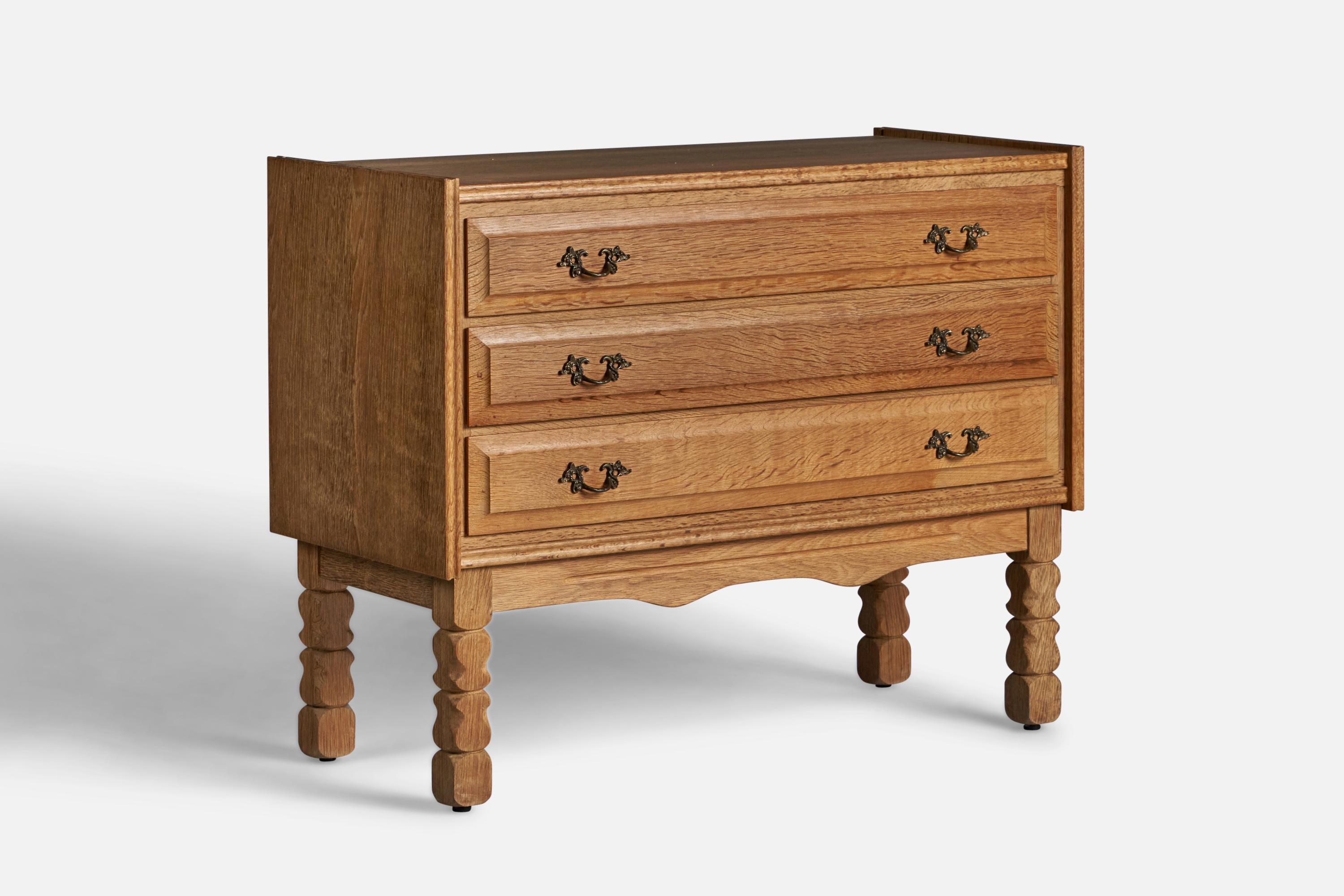 A caved solid oak chest of drawers designed and produced in Denmark, c. 1950s.