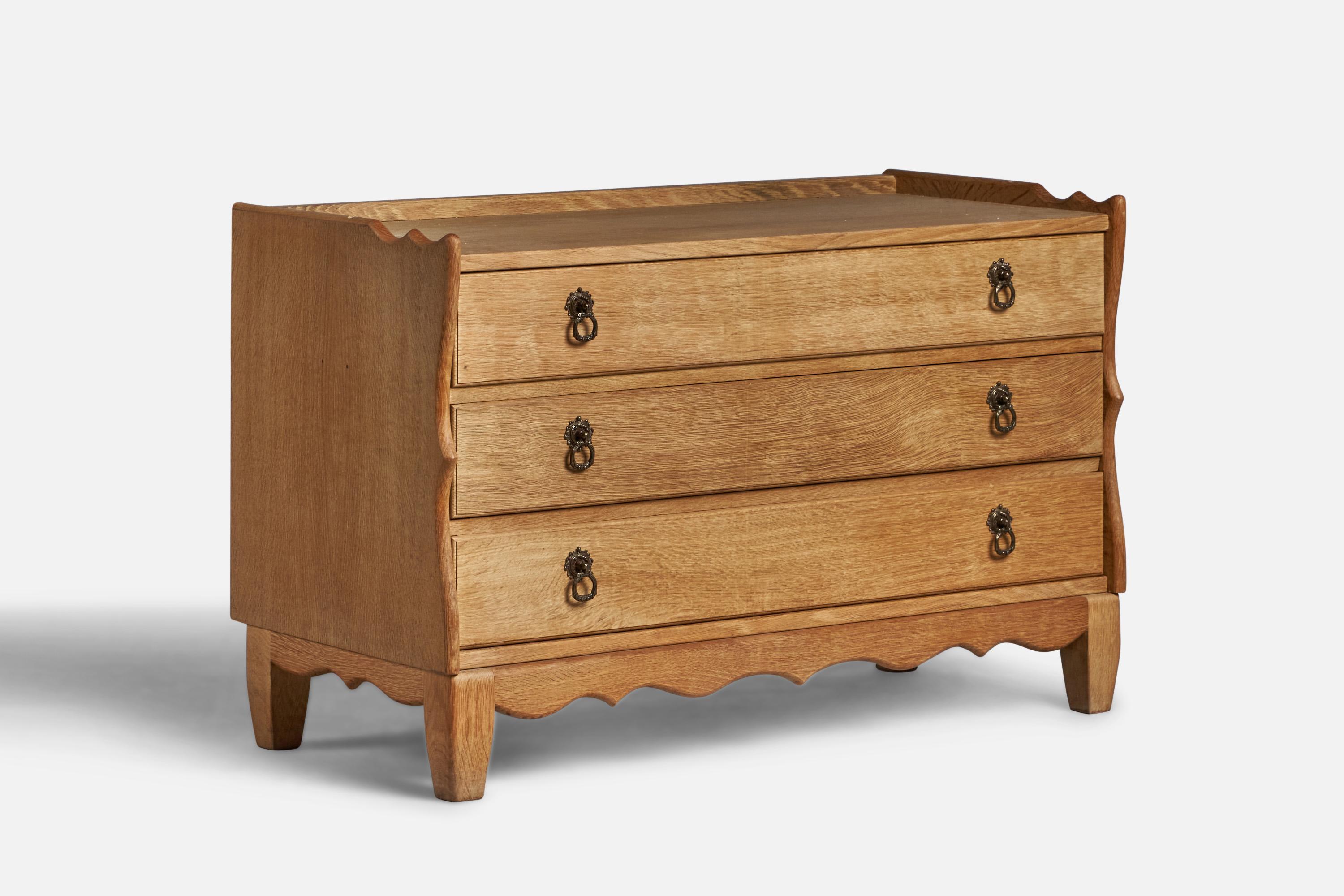 An oak and brass chest of drawers designed and produced in Denmark, 1950s.
 