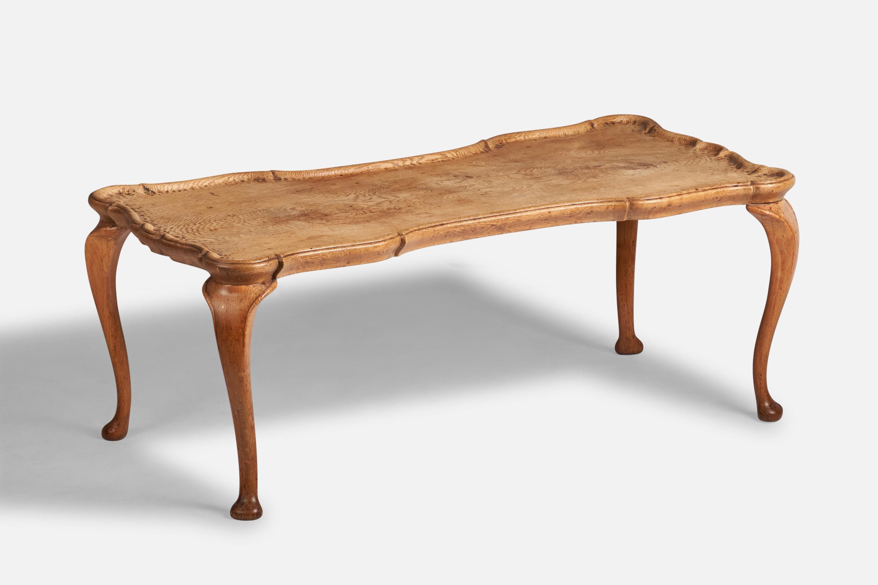 A carved oak coffee or cocktail table designed and produced in Denmark, c. 1930s.