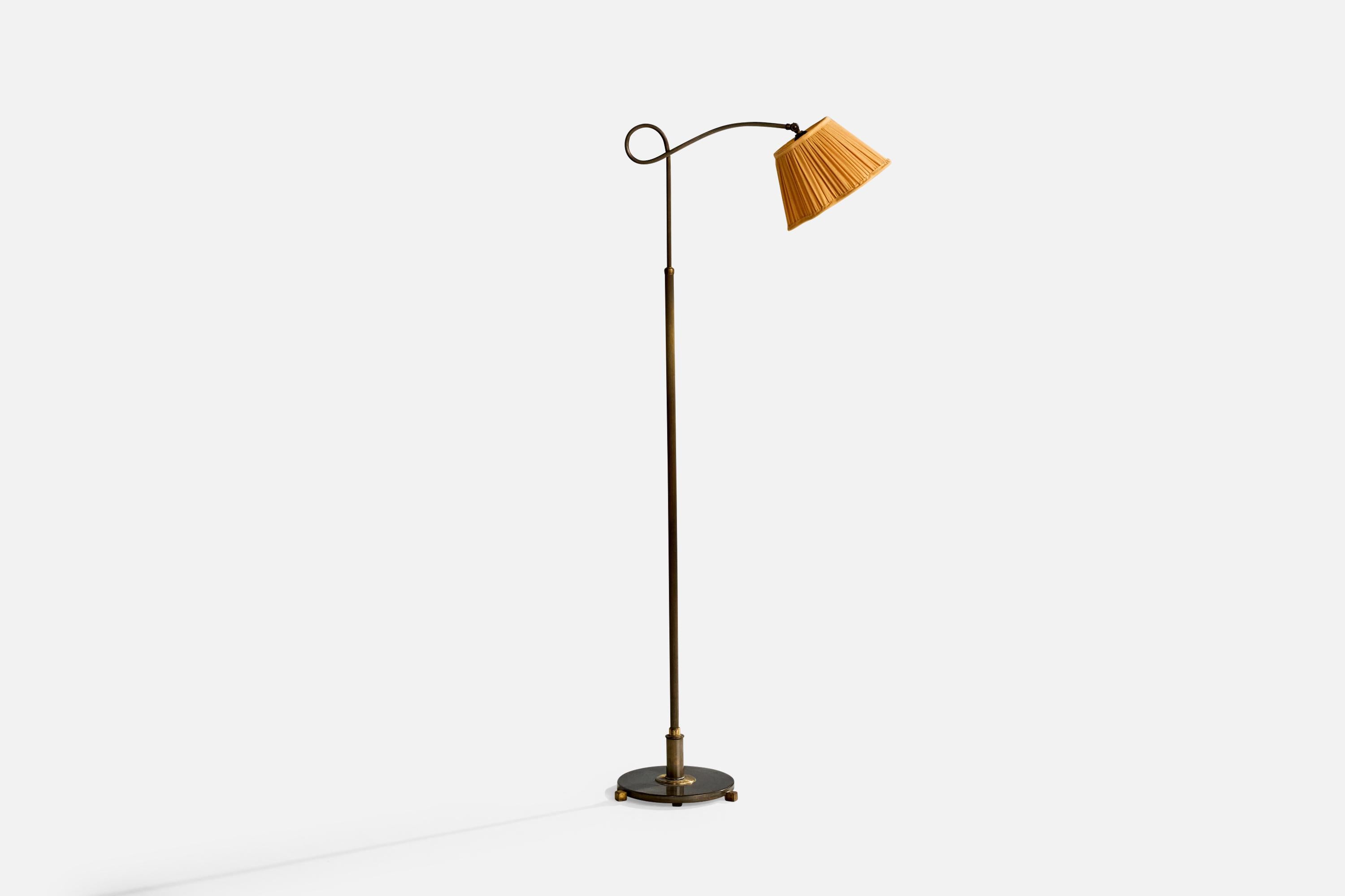 An adjustable brass and orange fabric floor lamp likely designed and produced in Denmark, c. 1930s.

Oxidation present to brass

Wear consistent with age and use

Overall height and shade adjustable; measured as shown

Overall Dimensions (inches):