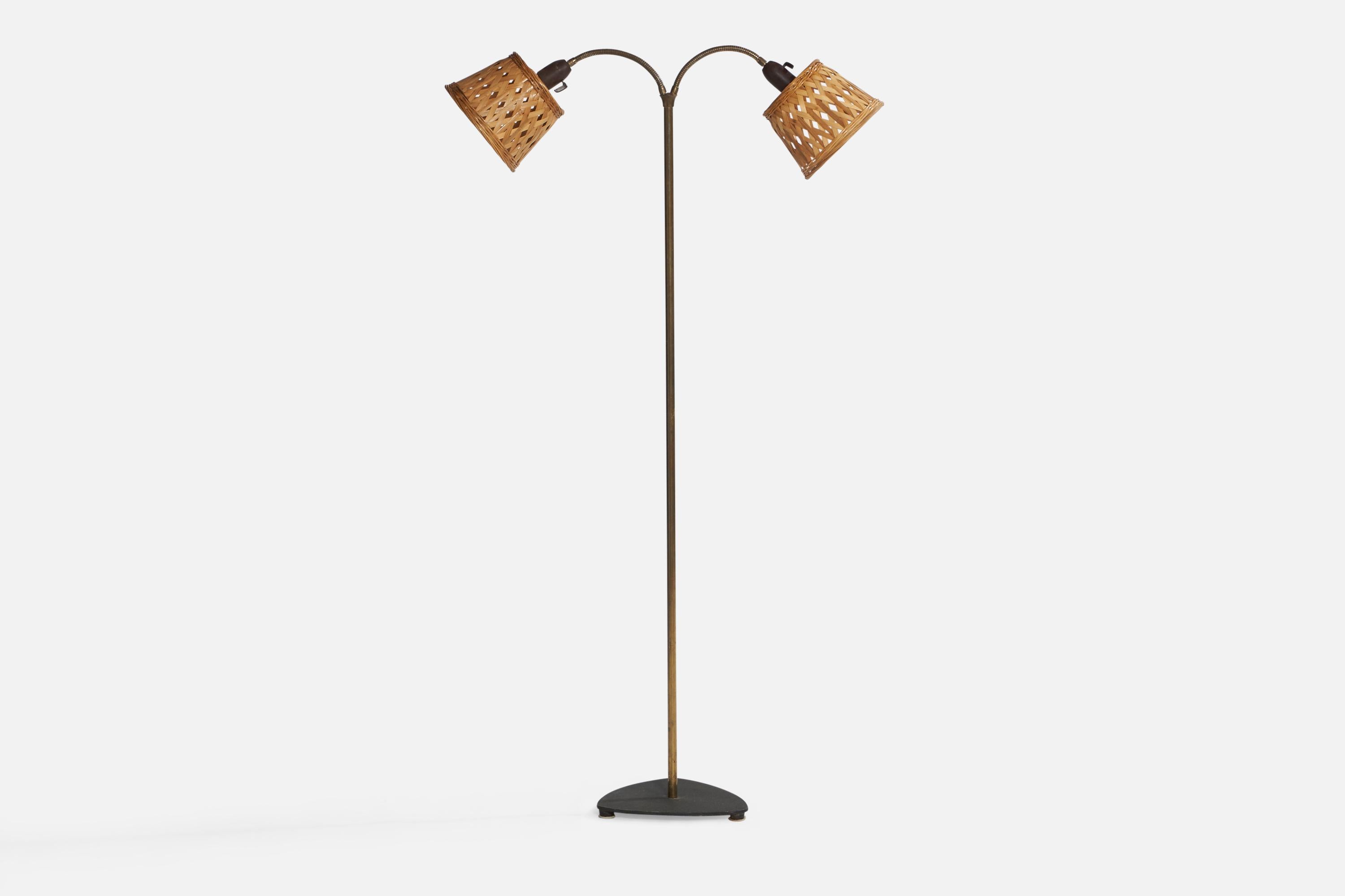 A brass, black-lacquered iron, bakelite and rattan floor lamp designed and produced in Denmark, 1940s.

Overall Dimensions (inches): 53.3” x 25.5” W x 20” D. Stated dimensions include shades.
Dimensions vary based on position of lights.
Bulb