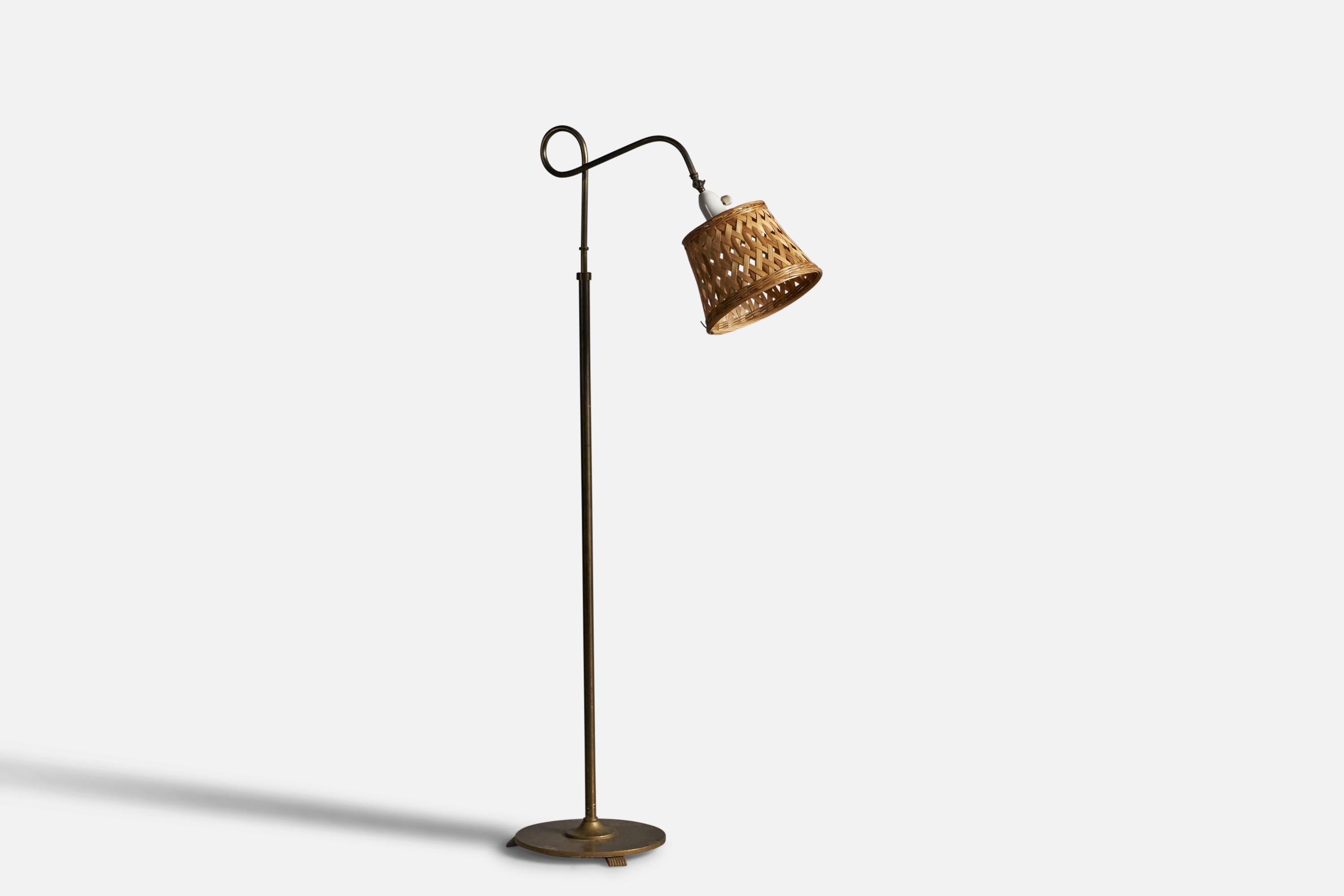 An adjustable brass and rattan floor lamp, designed and produced in Denmark, c. 1930s.

Overall Dimensions: 47