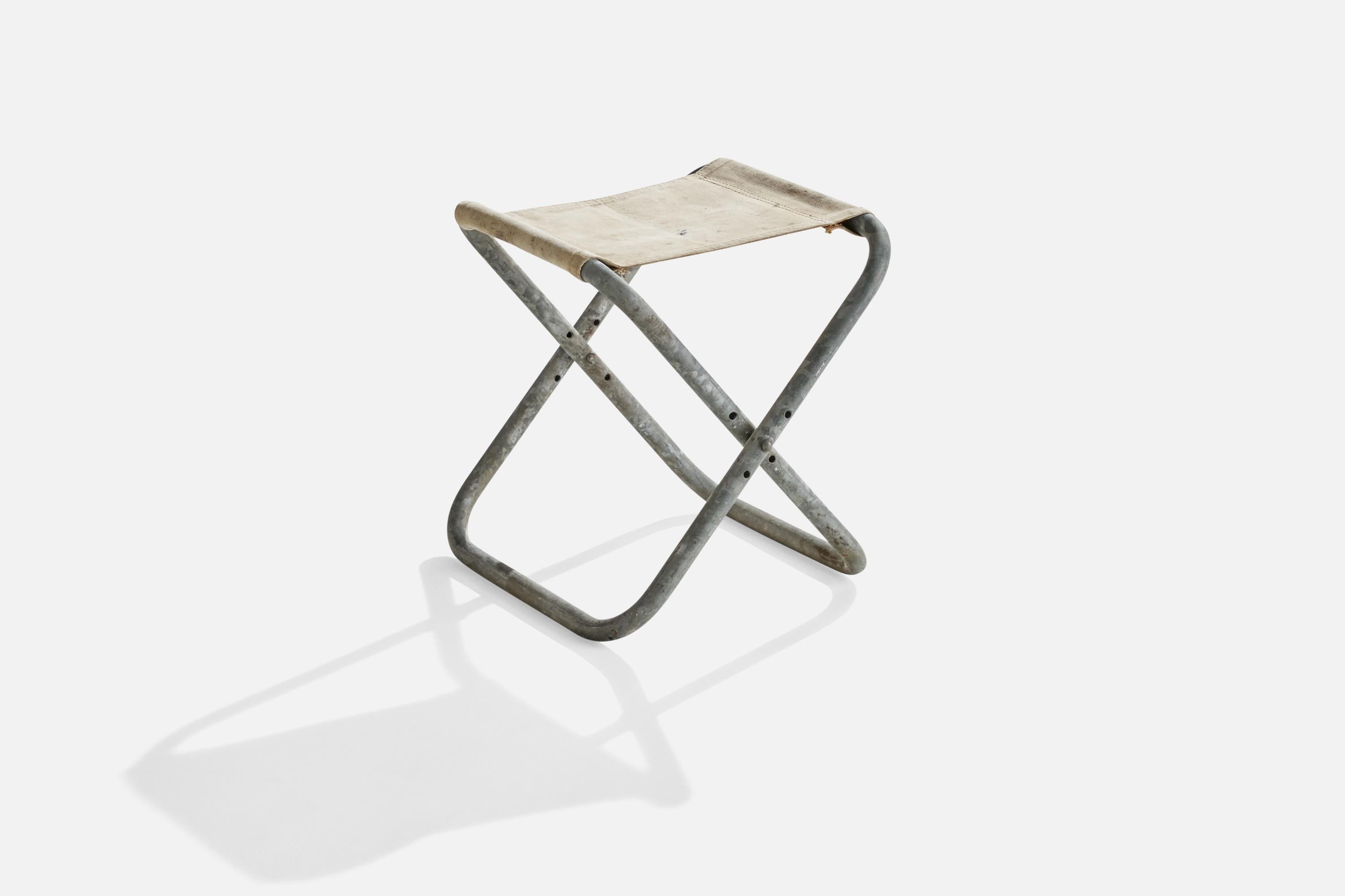 An off-white canvas and galvanized steel folding stool designed and produced in Denmark, c. 1940s.

seat height 15.75”.