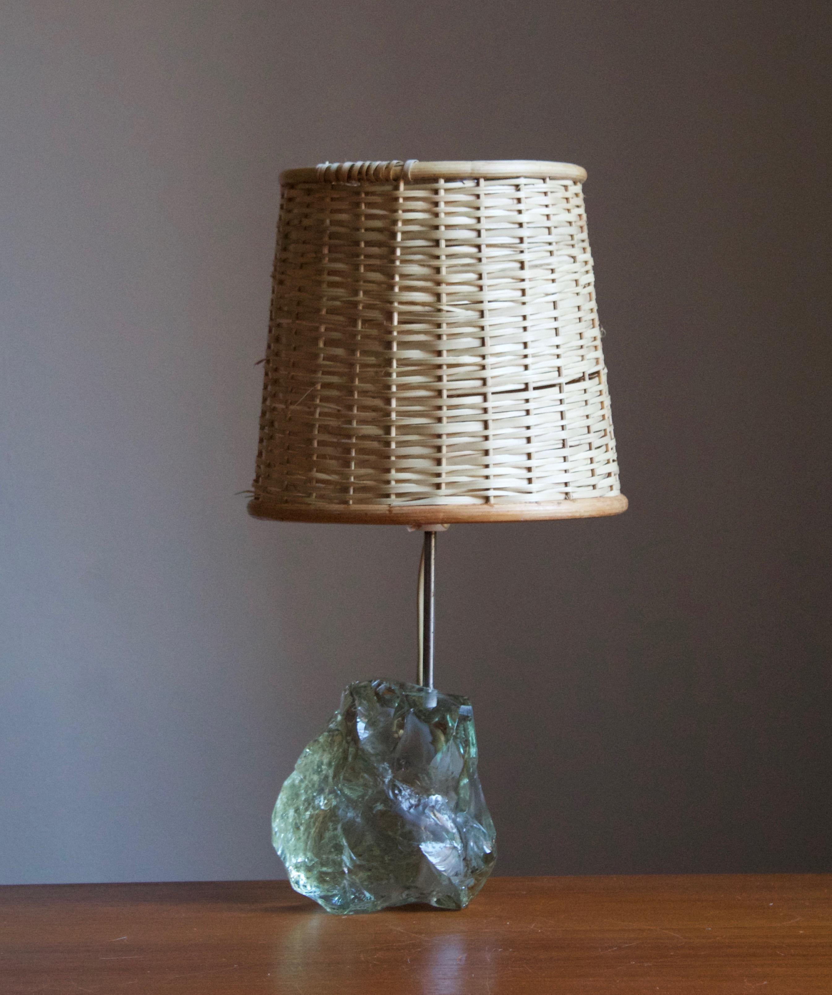 A table lamp, designed and produced in Denmark, c. 1960s. 

Stated dimensions exclude lampshade. Dimensions includes harp in the position illustrated in the images. Illustrated basket lampshade can be included upon request.

Other designers