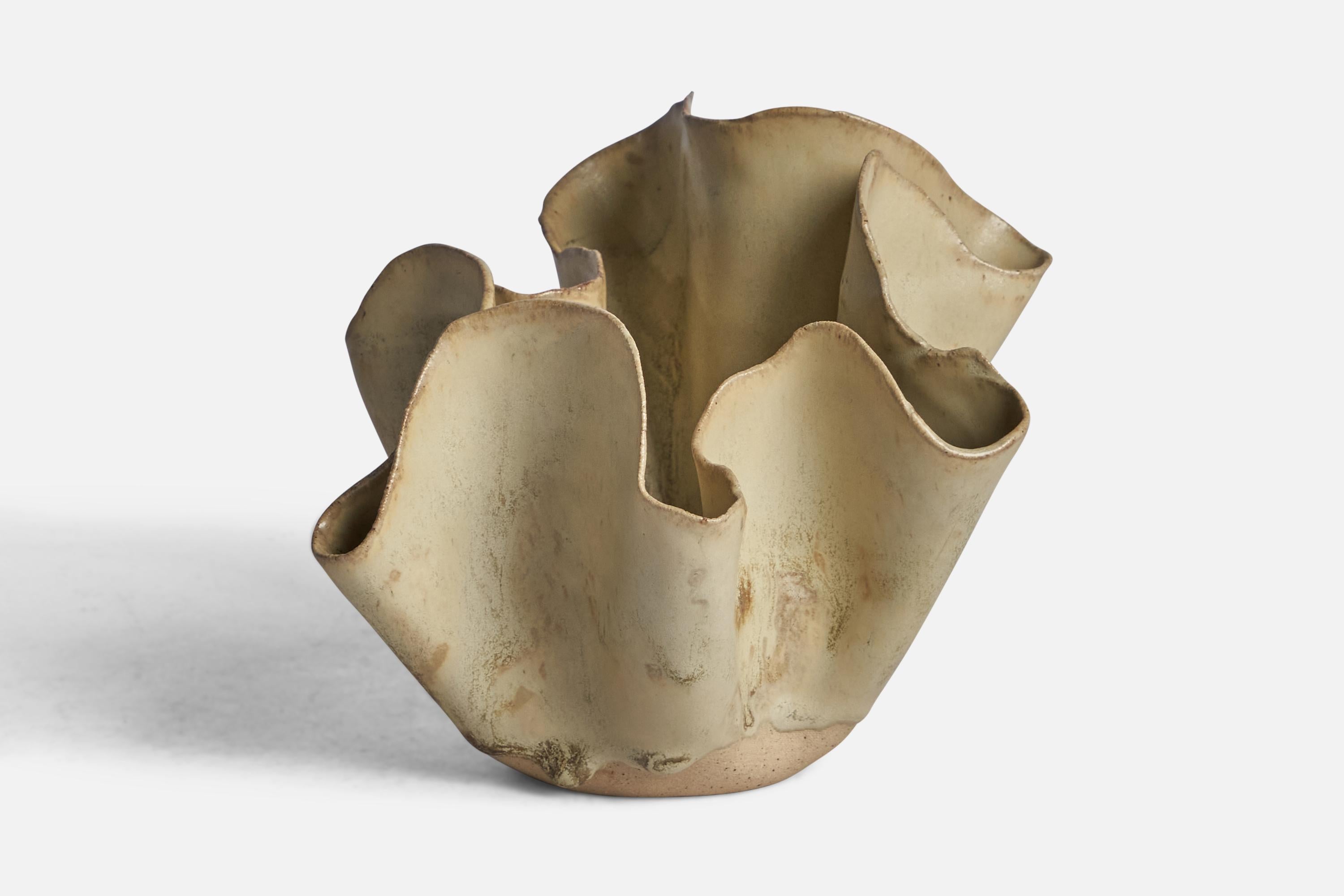 A beige-glazed ceramic freeform vase designed and produced in Denmark, 1960s.