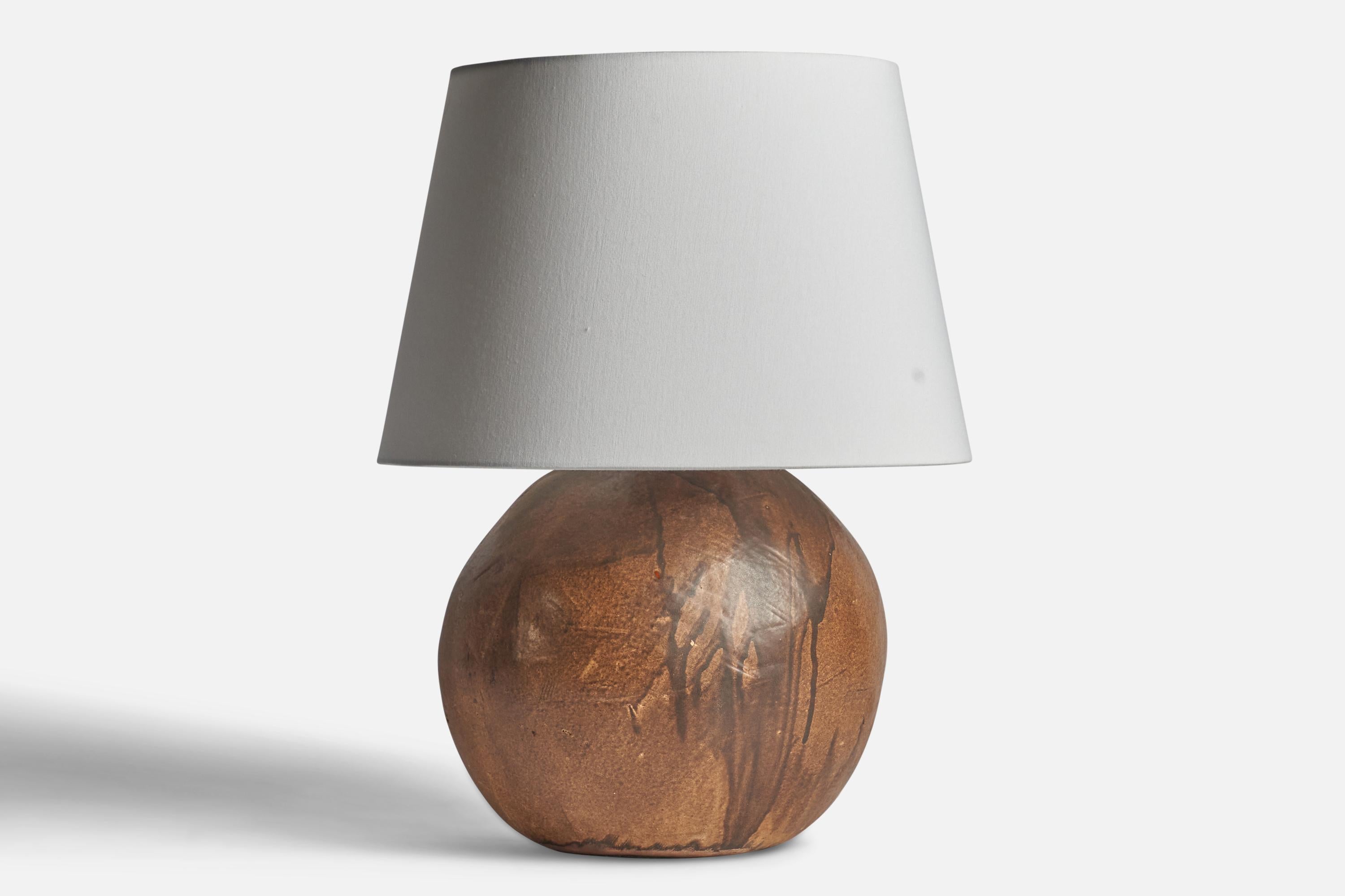 A large brown-glazed ceramic table lamp designed and produced in Denmark, c. 1960s.

Dimensions of Lamp (inches): 16.5” H x 12.5” Diameter
Dimensions of Shade (inches): 12” Top Diameter x 16” Bottom Diameter x 10.75” H
Dimensions of Lamp with Shade