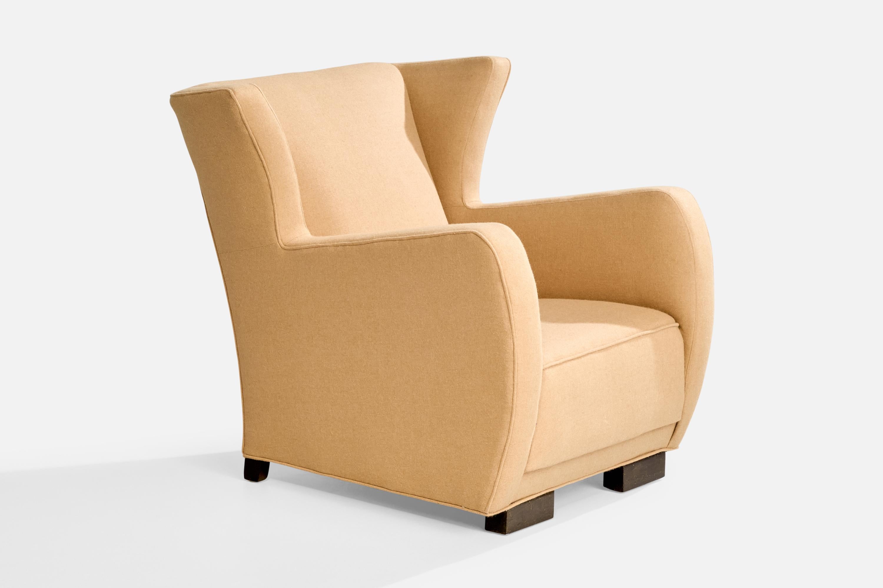 A beige fabric and dark-stained wood lounge chair designed and produced in Denmark, c. 1930s.

Reupholstered in brand new fabric.

Dimensions: 32.65” H x 34.5” W x 34” D

Seat Height: 14.75”