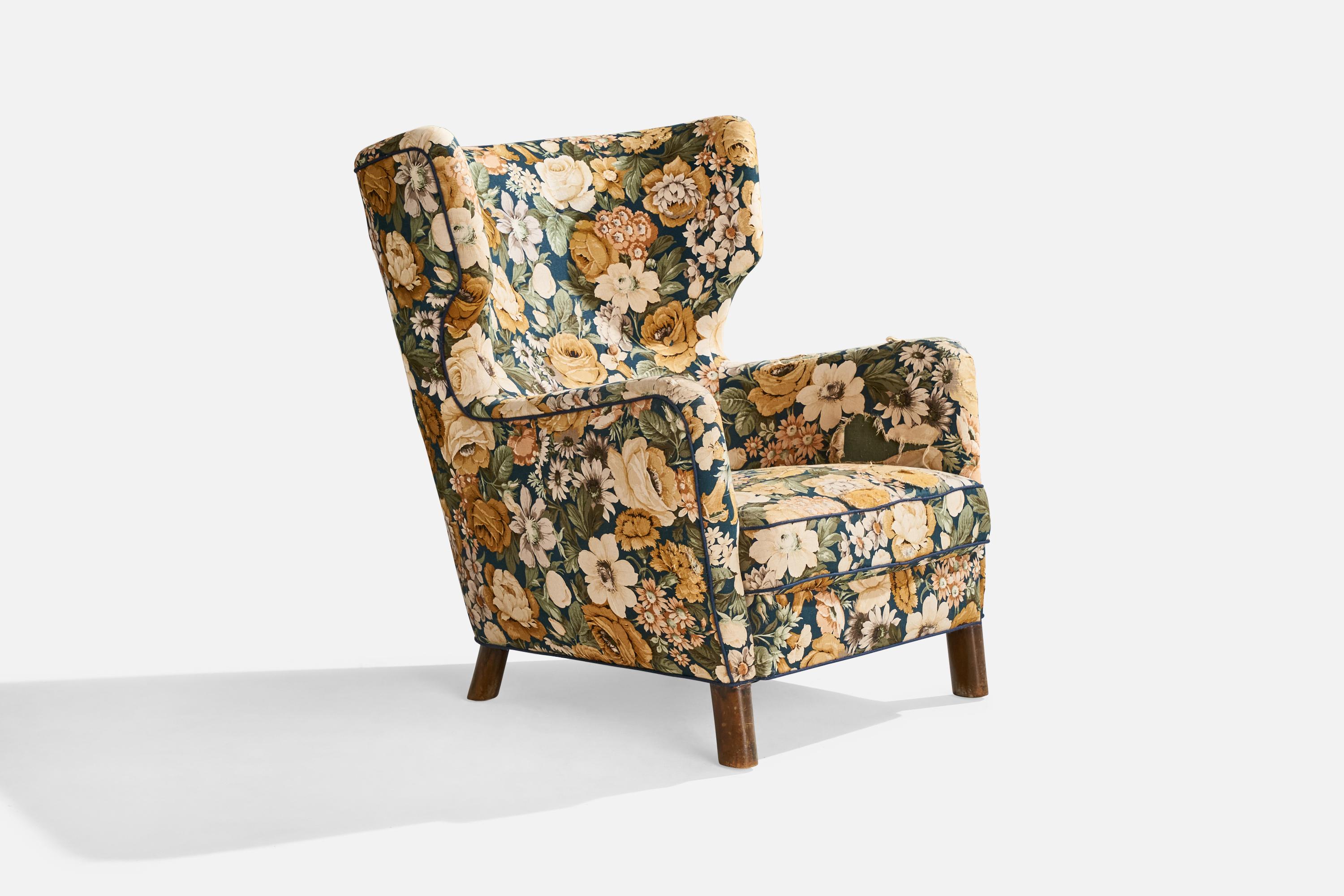 A floral fabric and dark-stained wood lounge chair designed and produced in Denmark, c. 1940s.

Seat height: 15.5”

