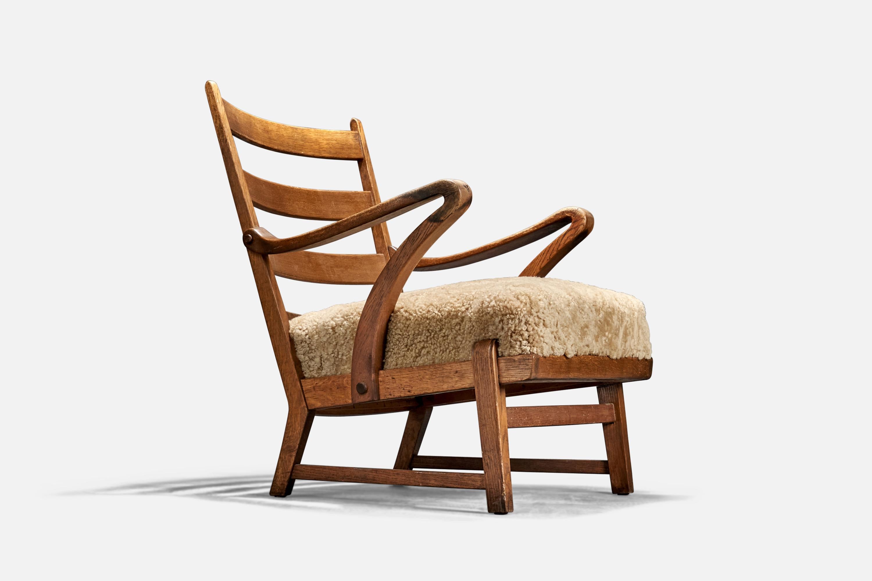 An oak and shearling lounge chair designed and produced in Denmark, 1940s.