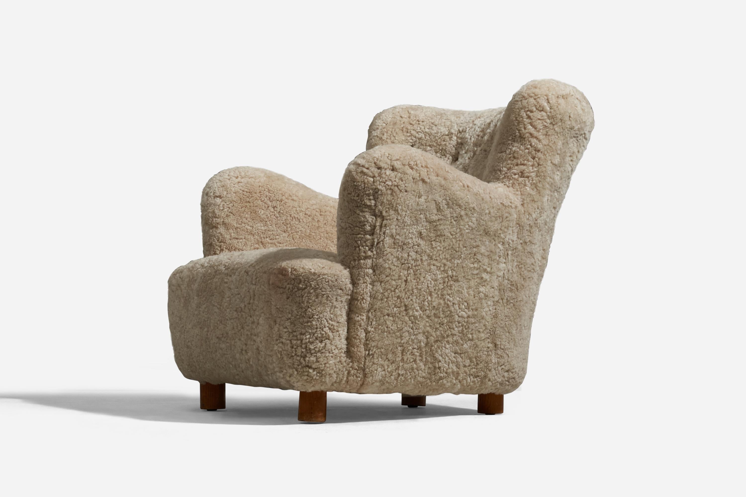 A shearling and beech lounge chair designed and produced in Denmark, 1940s.