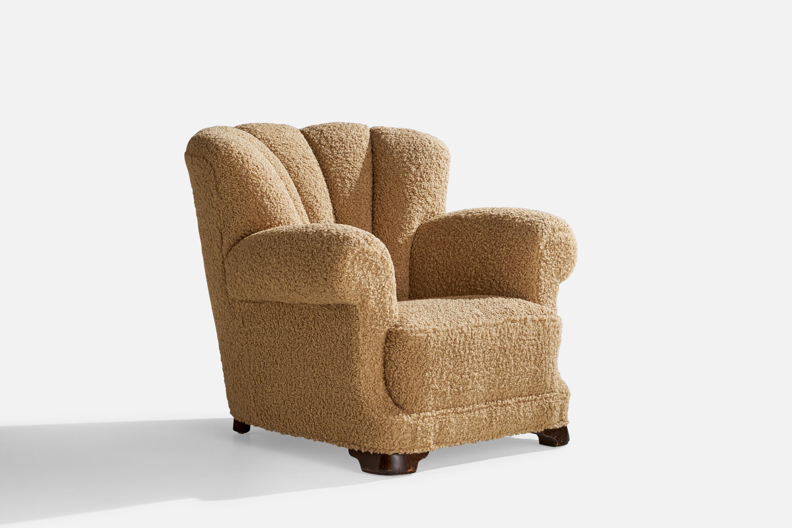 A dark-stained wood and beige bouclé fabric lounge chair designed and produced in Denmark, 1930s.

Seat height 16”