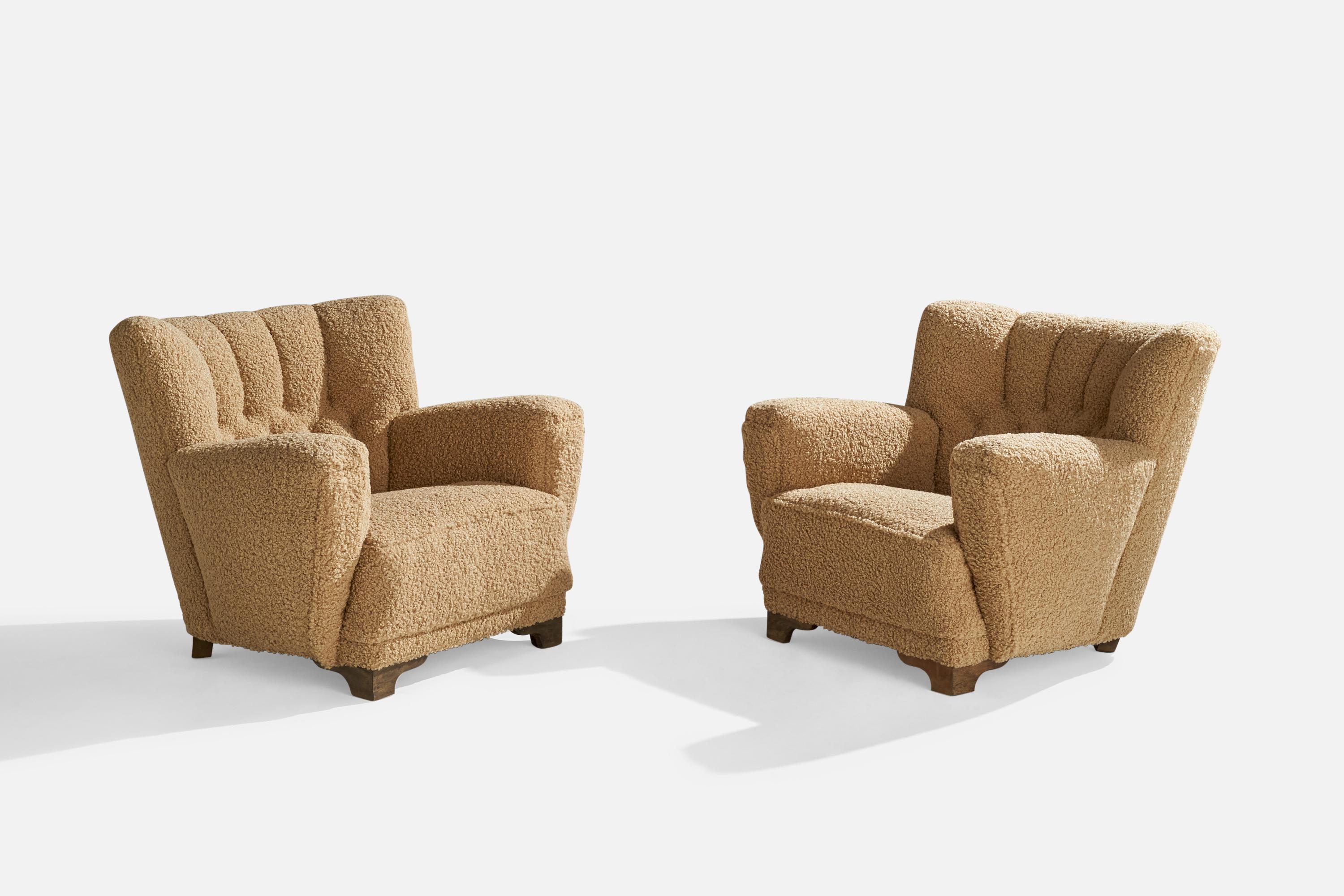 A pair of beige bouclé fabric and oak lounge chairs designed and produced in Denmark, 1940s.

Seat height 15.5”.