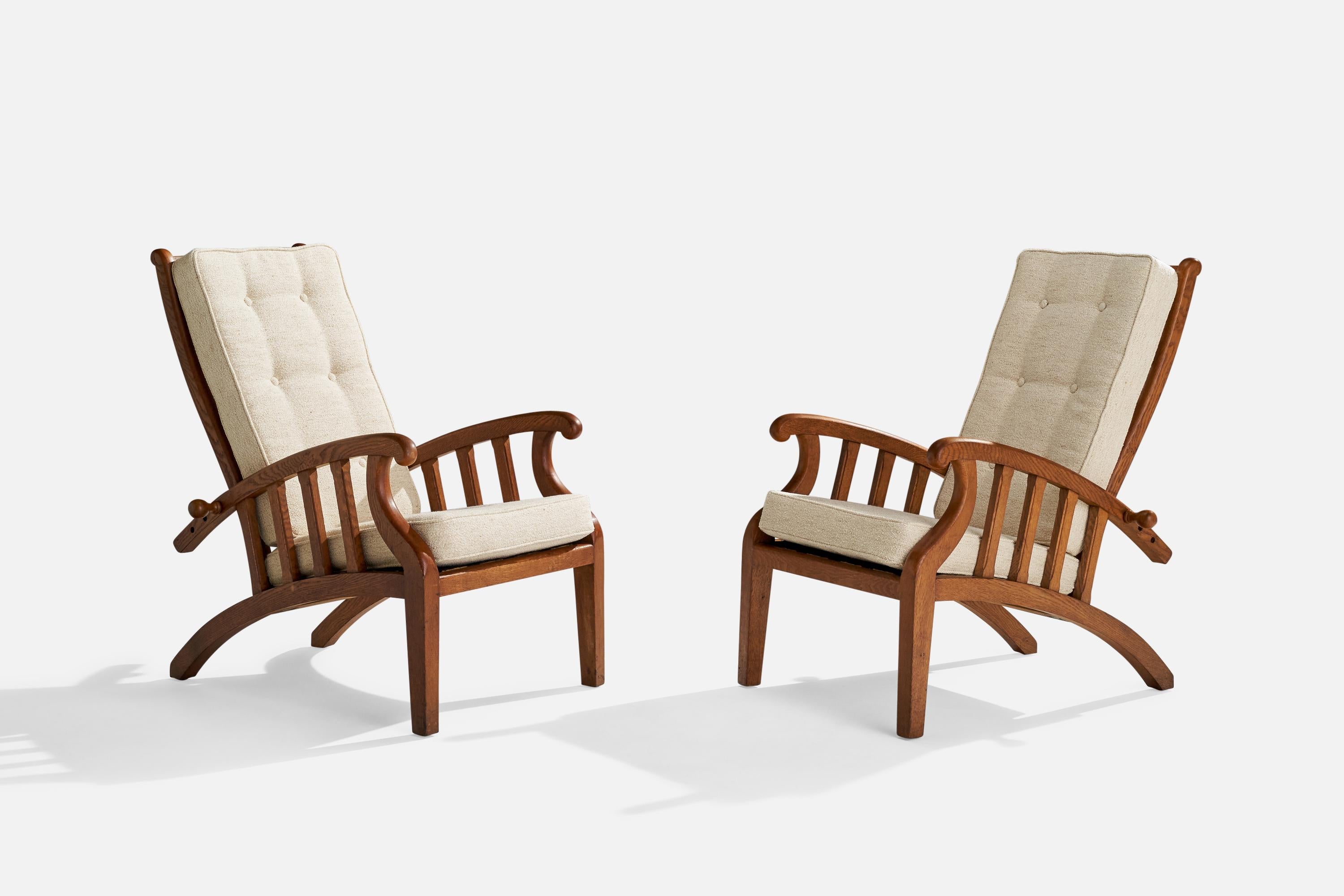A pair of adjustable stained oak and white fabric lounge chairs designed and produced in Denmark, c. 1920s.

Seat height 17.5”.