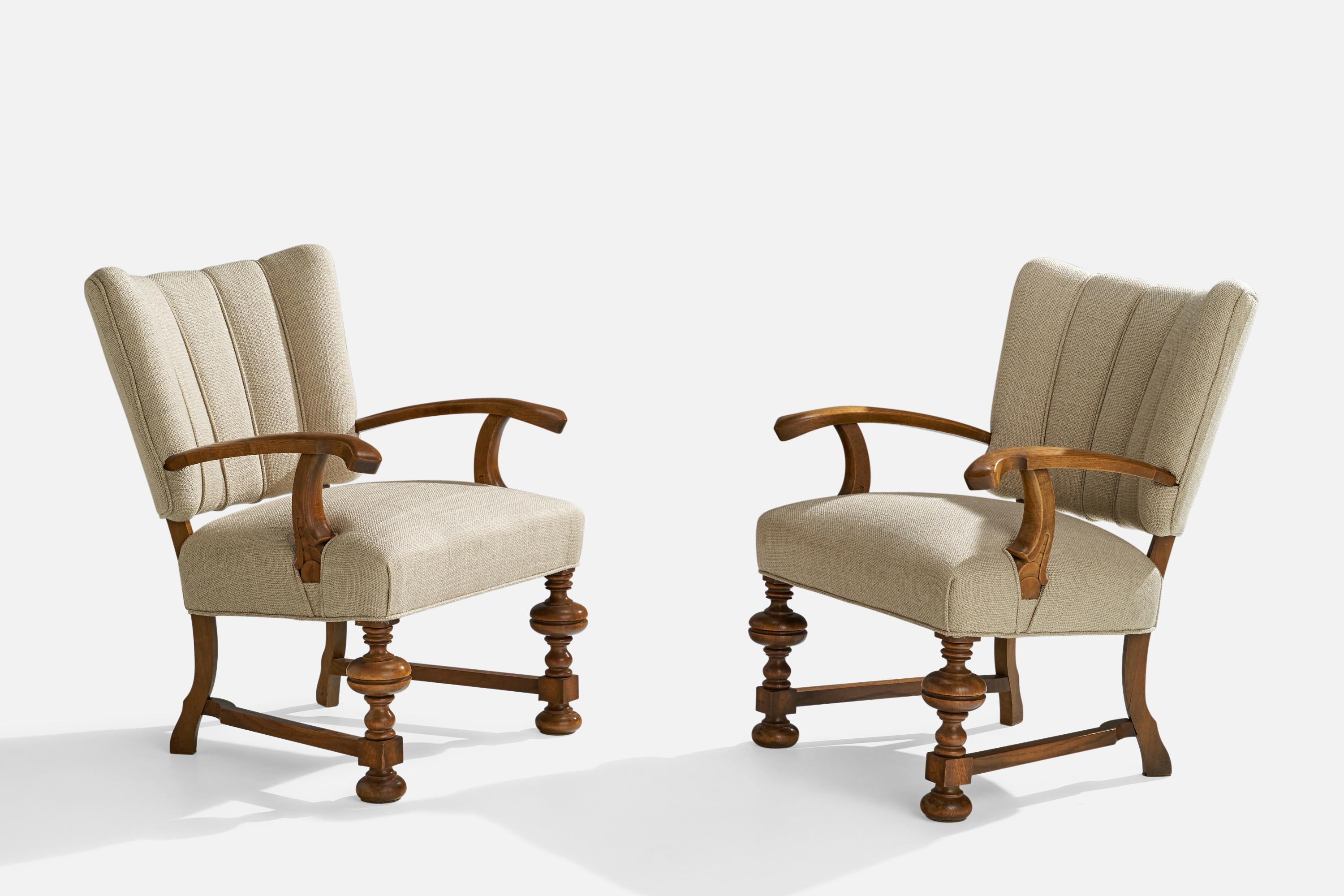 A pair of oak and off-white fabric lounge chairs or armchairs designed and produced in Denmark, c. 1930s.

Seat height 17.5”.