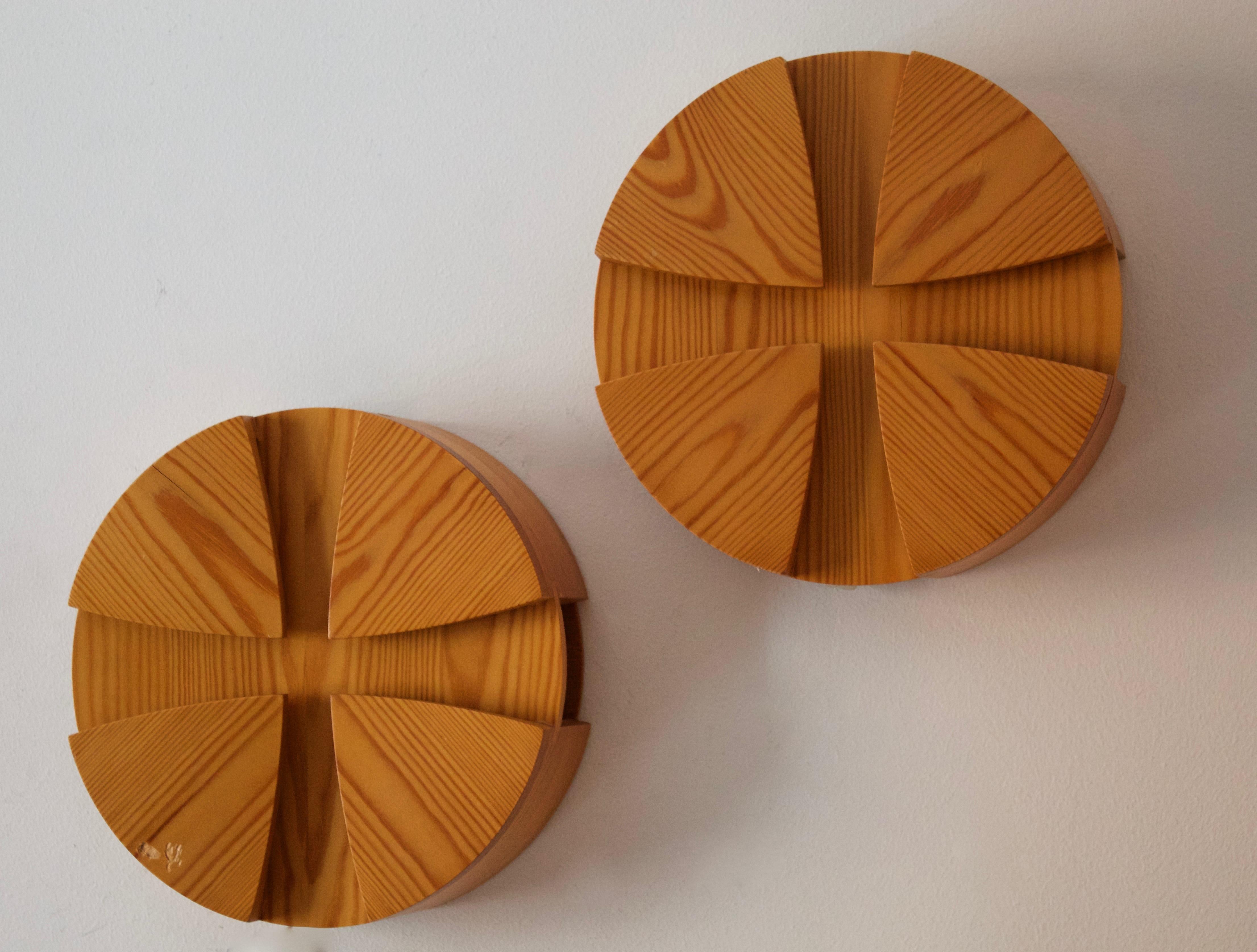 A pair of wall lights, designed and produced in Denmark, 1970s. In solid pine. 

Each takes two lightbulbs on E27 sockets. Please review wiring upon installation.