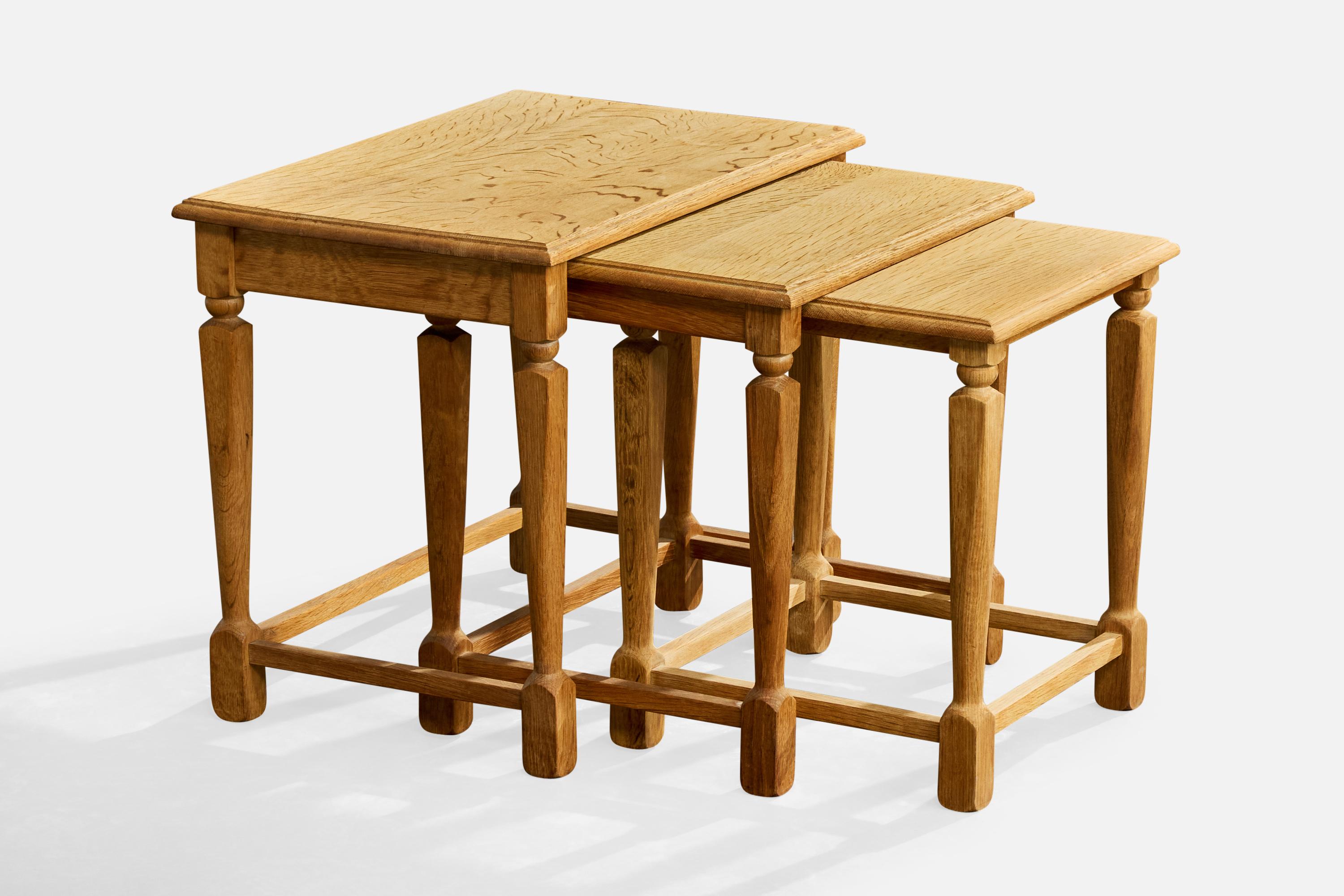 A set of three oak nesting tables designed and produced in Denmark, c. 1960s.

Minor staining on largest and middle tabletops.

Dimensions of smallest table: 17.5” H x 15.5” W x 15.75
