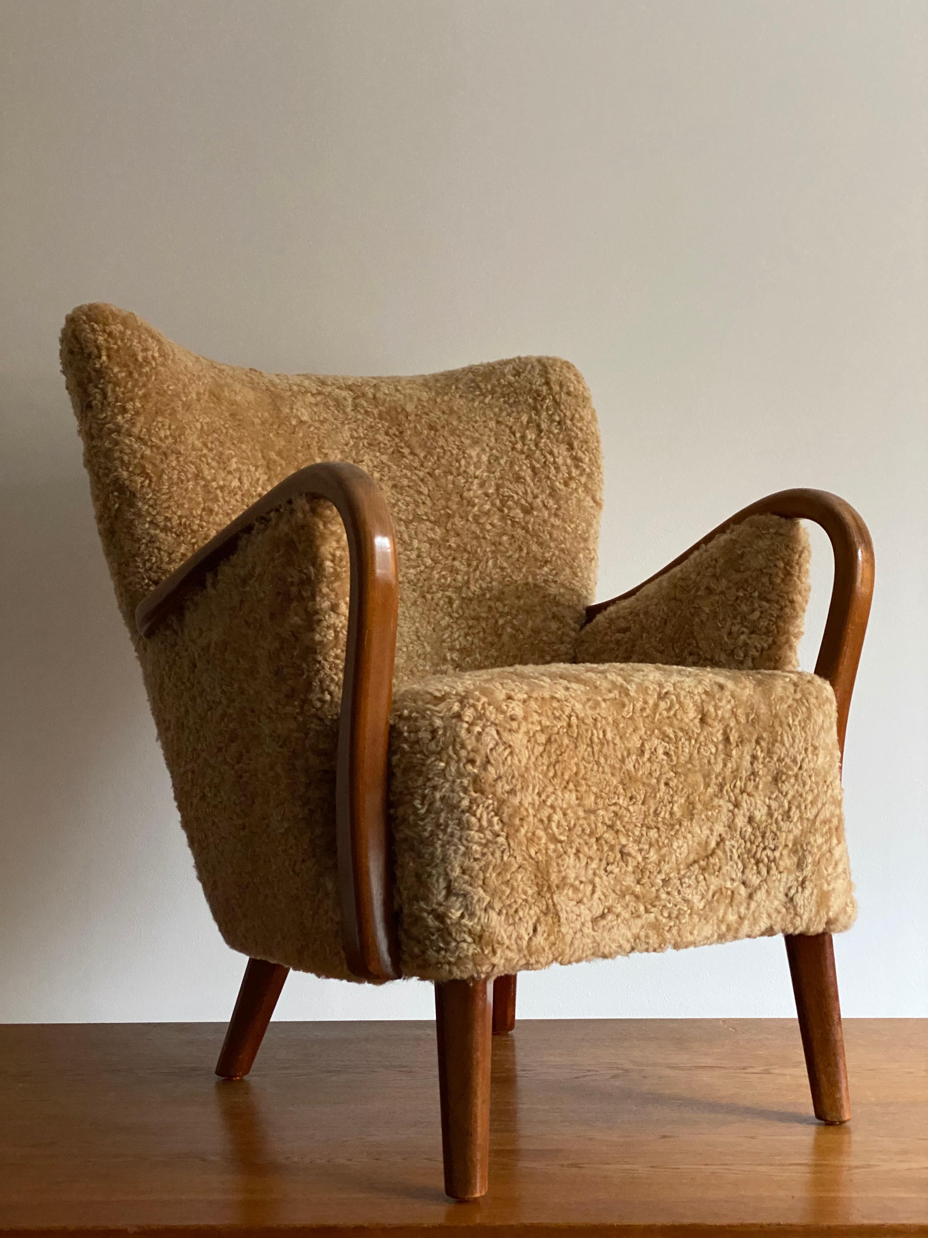 An organic lounge chair or armchair, designed by an unknown Danish modernist designer, late 1940s or early 1950s.

The sofa organic form is further enhanced by the sheepskin upholstery.

Other designers working in similar organic style include