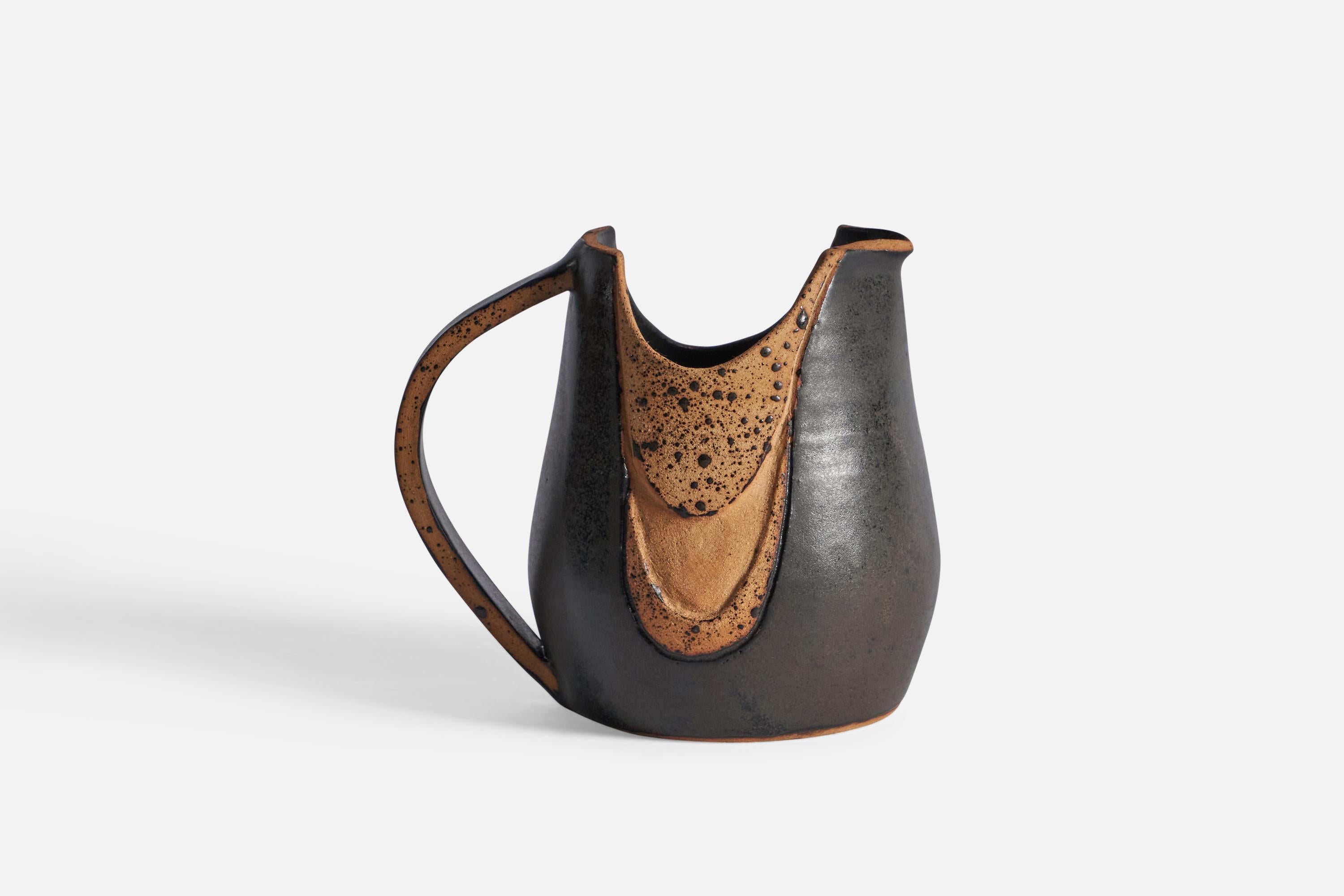 A semi-glazed brown stoneware pitcher, designed and produced in Denmark, c. 1960s.