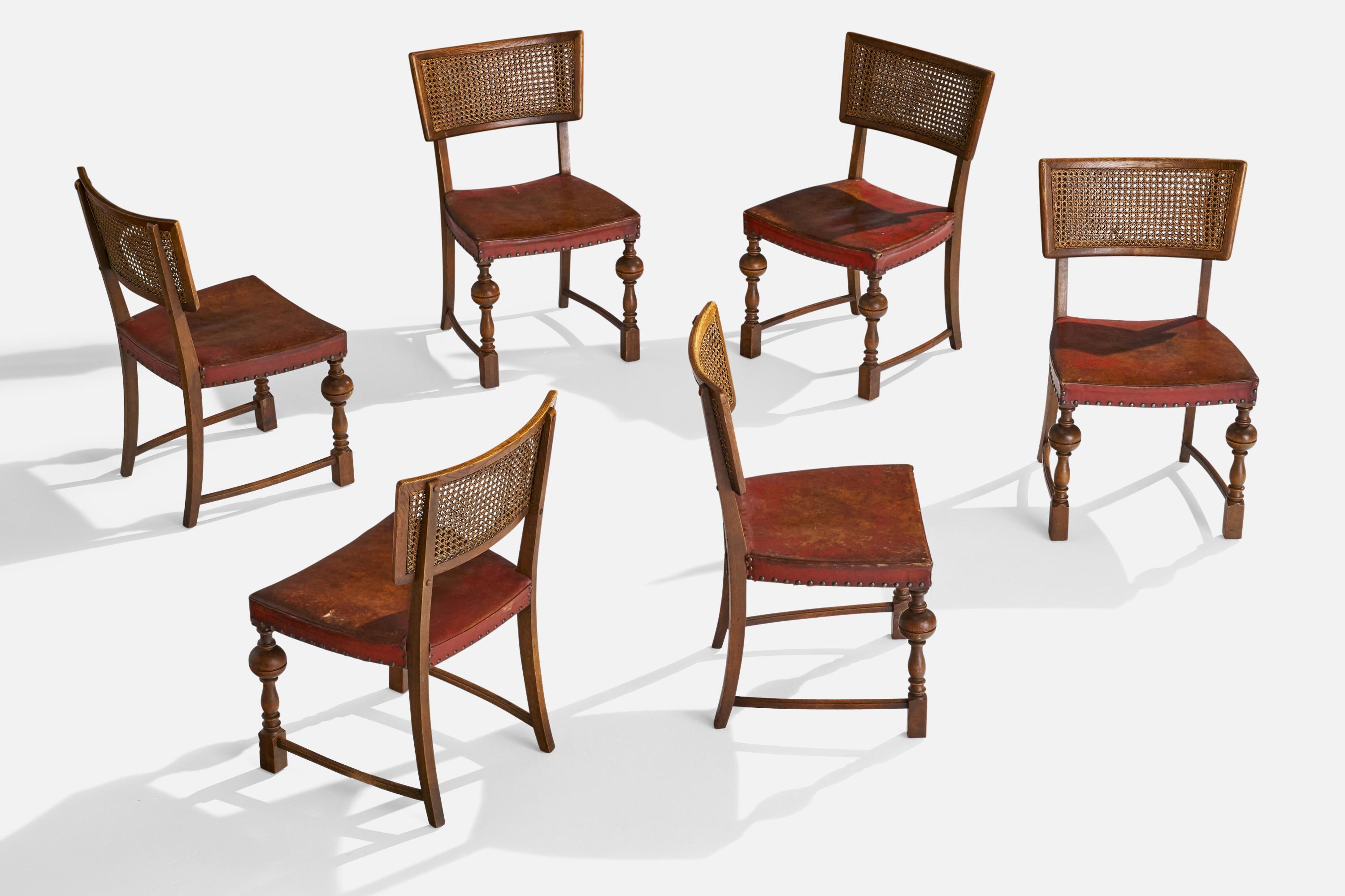 A set of 6 oak, cane and red leather side or dining chairs designed and produced in Denmark, 1930s.

Seat height: 16.75”