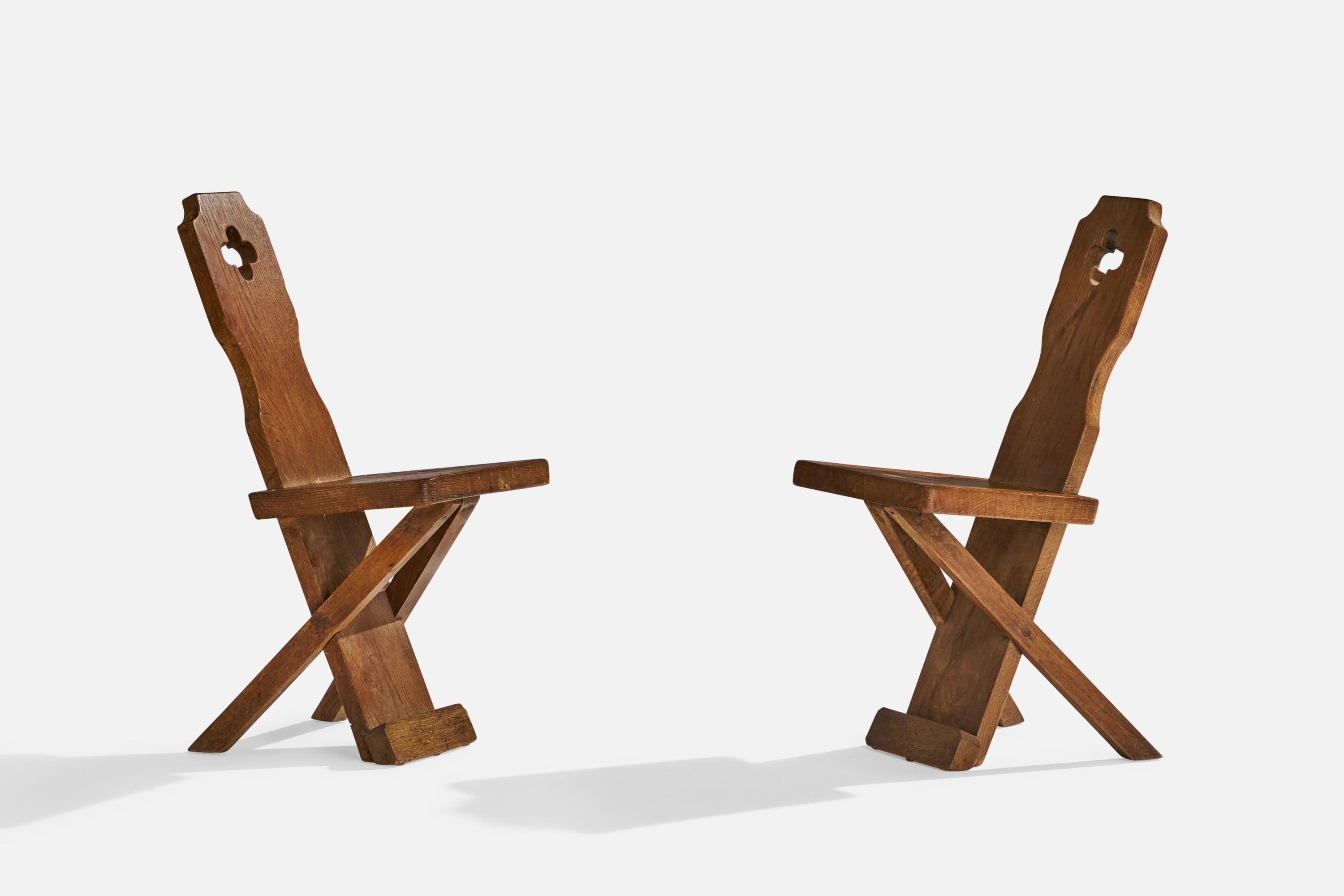 A pair of oak side chairs or dining chairs designed and produced in Denmark, c. 1920s.

Seat height 18”.