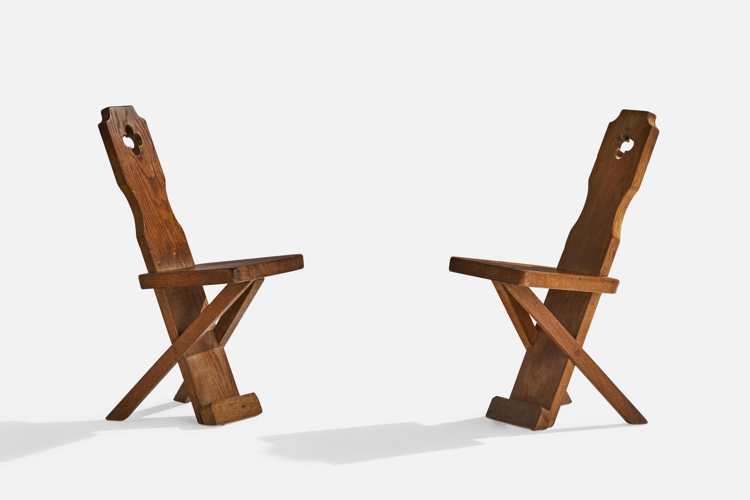A pair of oak side chairs or dining chairs designed and produced in Denmark, c. 1920s.

Seat height 18”.