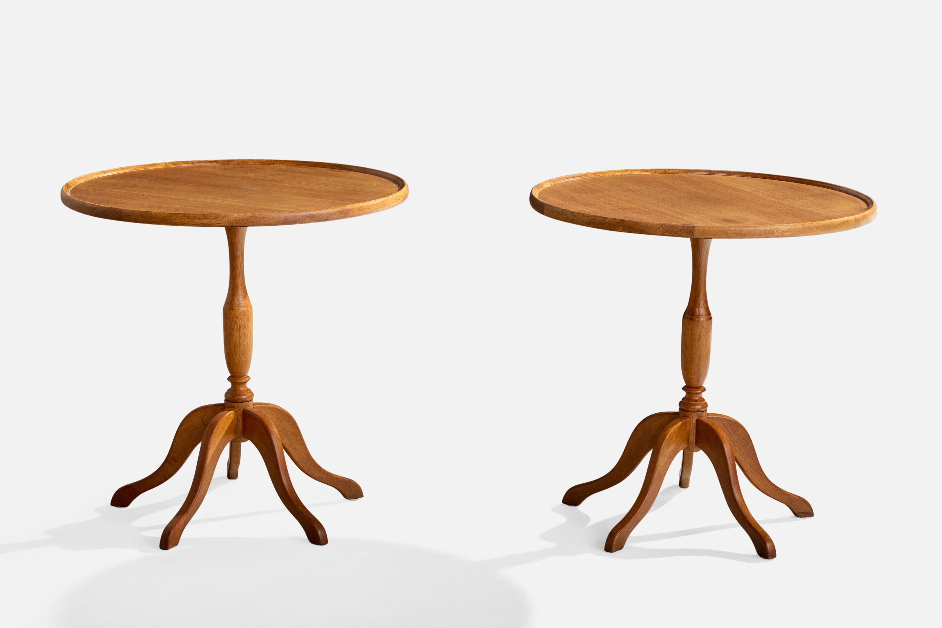 A pair of oak side tables likely designed and produced in Denmark, c. 1940s.

Water rings lightly present to wood tabletops

Wear consistent with age and use

Overall Dimensions (inches): 25.0