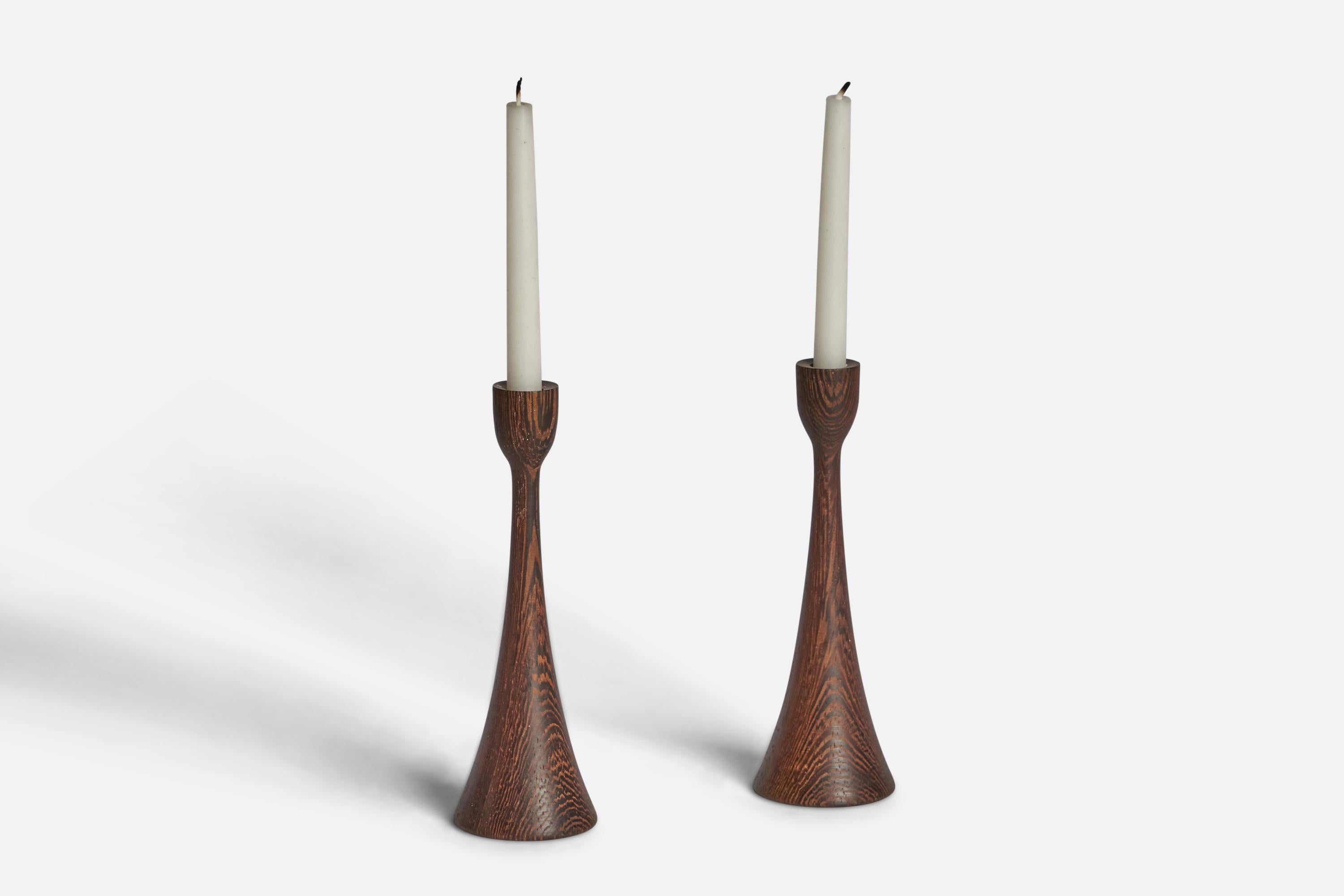 A pair of small wenge candlesticks designed and produced in Denmark, 1950s.

Fits 0.45” diameter candles
”DENMARK“ stamp on bottom