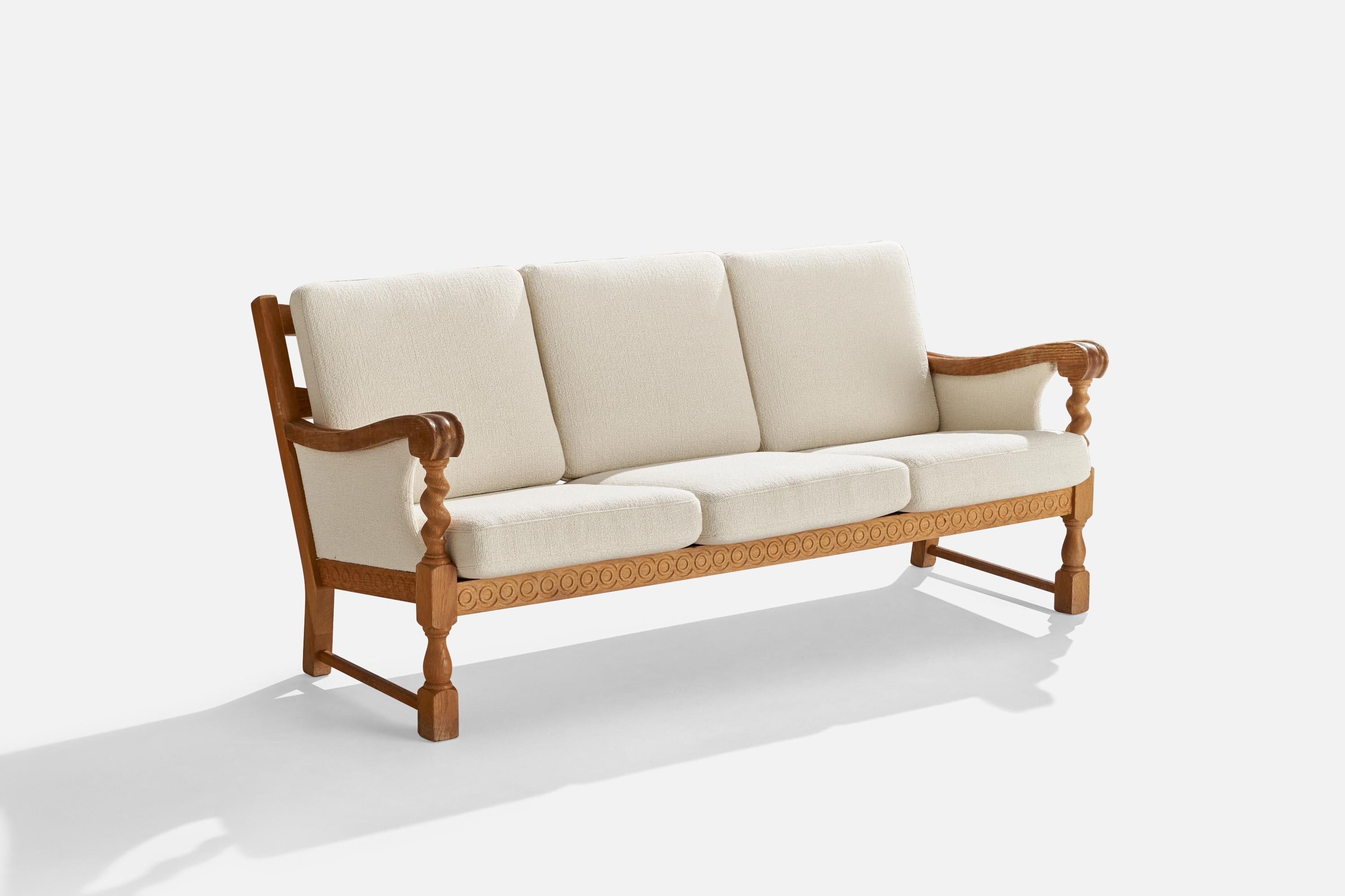 An oak and white fabric sofa designed and produced in Denmark, c. 1960s.

Seat height: 17”