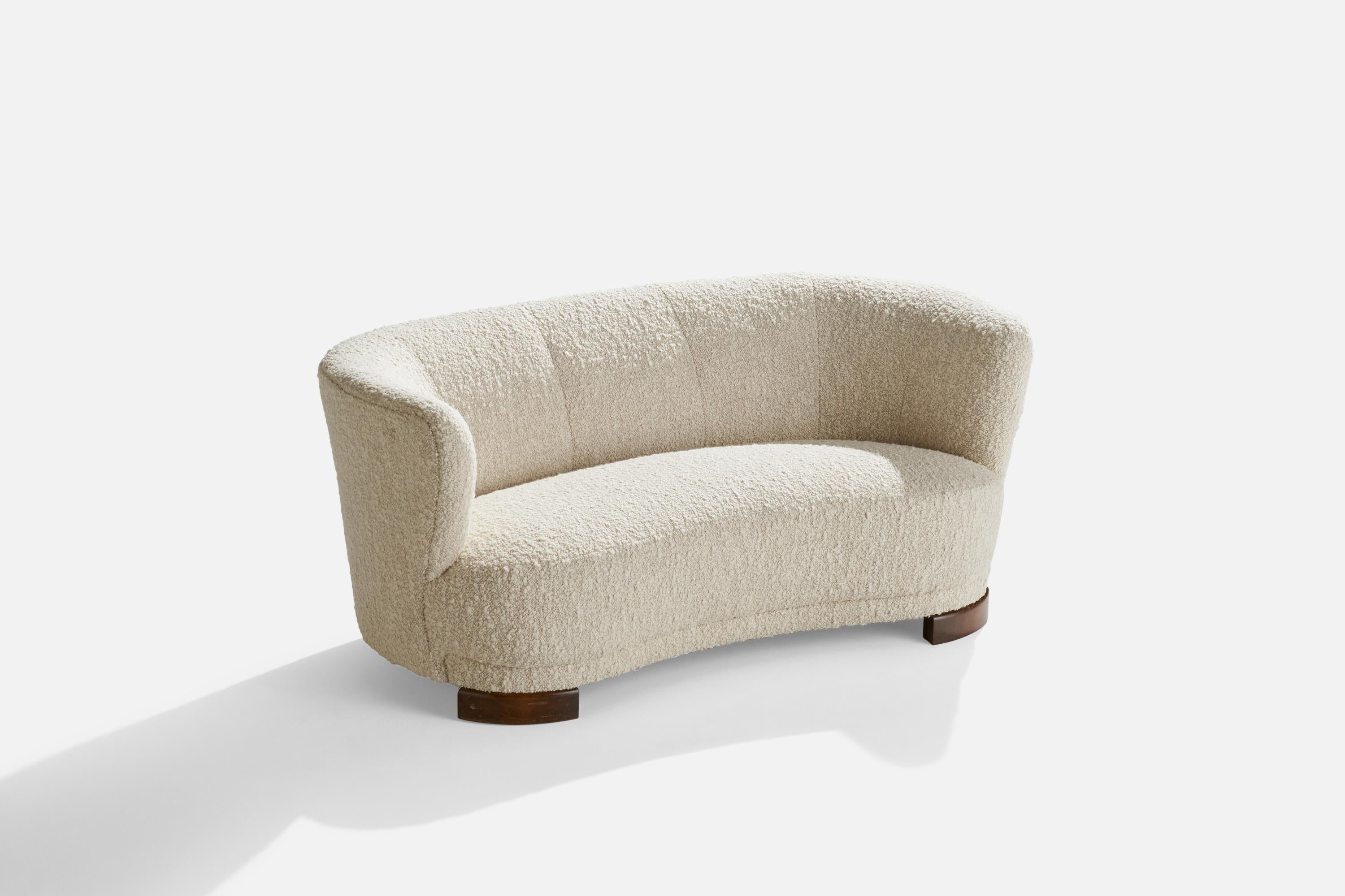 An off-white bouclé fabric and dark-stained wood sofa designed and produced in Denmark, 1940s.

Seat height: 14”