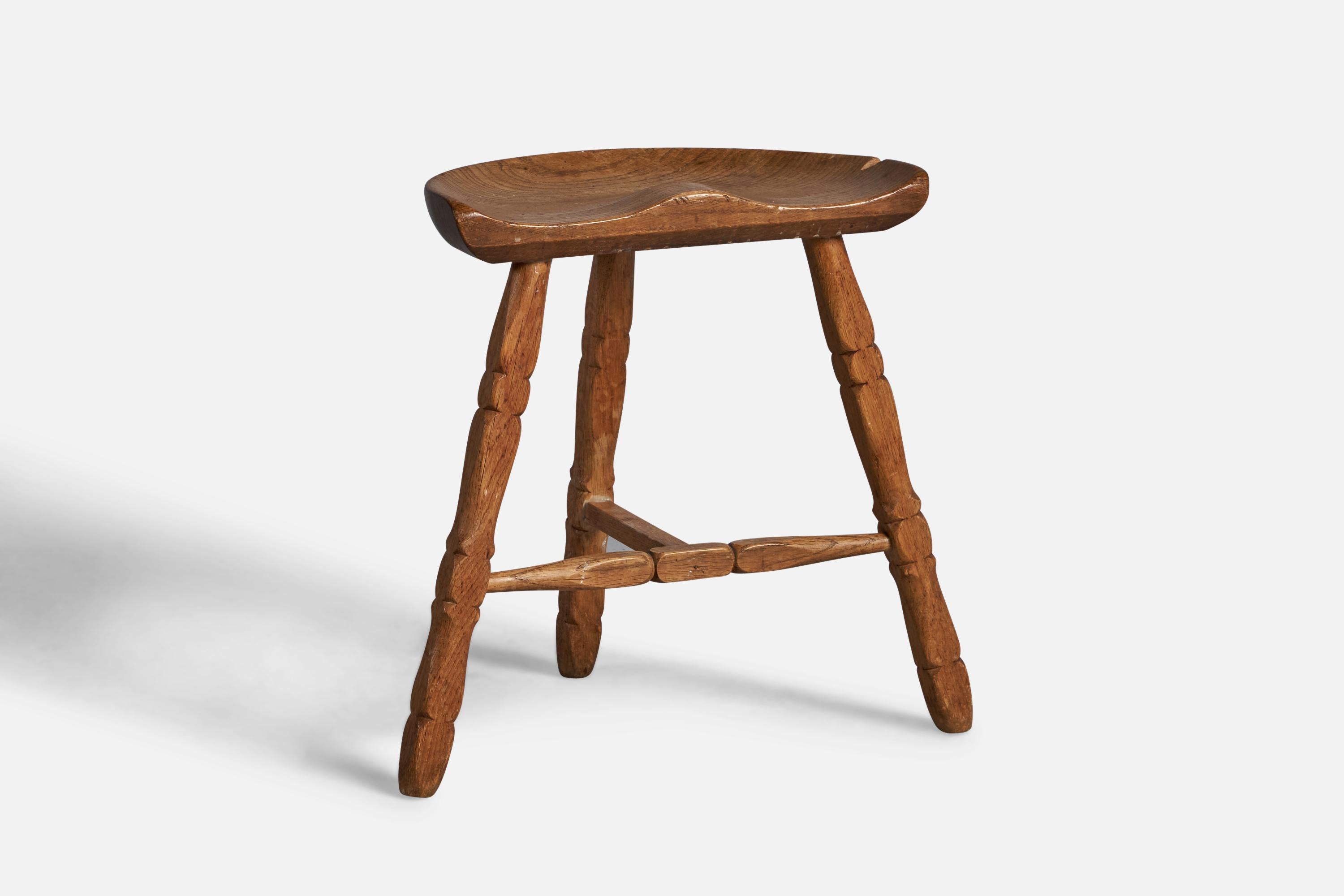 A solid oak stool, designed and produced in Denmark, 1950s.
