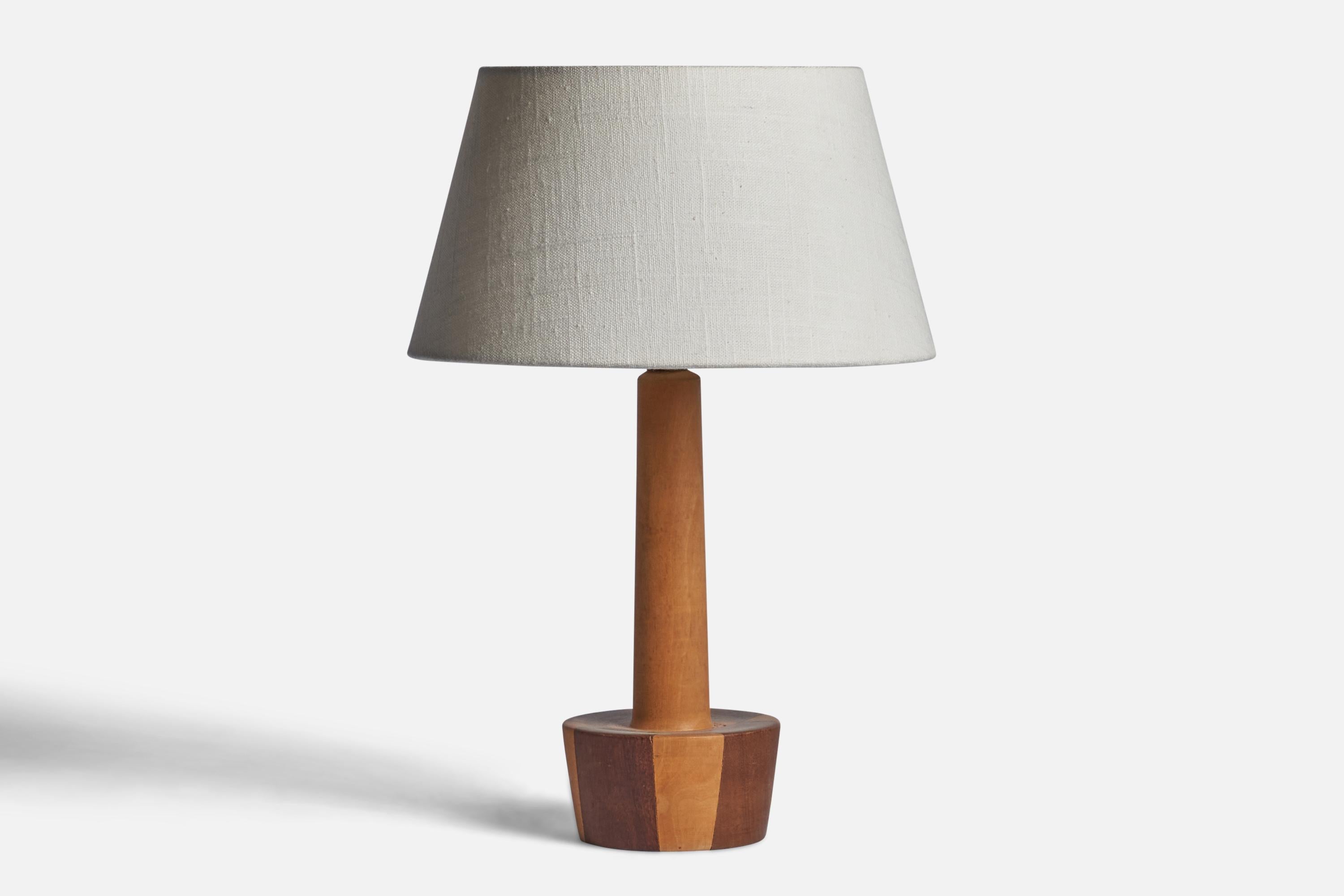 A beech and teak table lamp designed and produced in Denmark, c. 1950s.

Dimensions of Lamp (inches): 12” H x 4.25” Diameter
Dimensions of Shade (inches): 7” Top Diameter x 10” Bottom Diameter x 5.5” H 
Dimensions of Lamp with Shade (inches): 14.65”