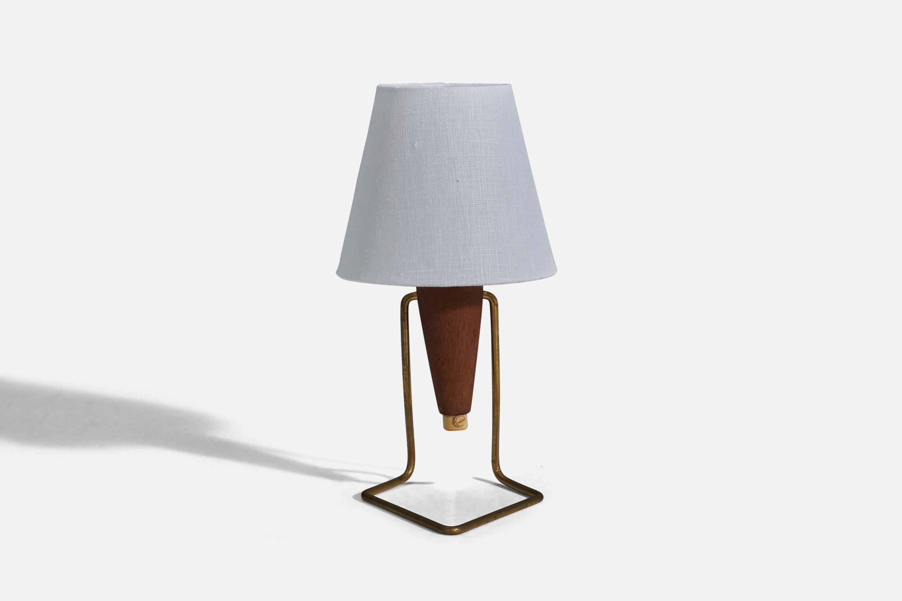A brass and teak table lamp designed and produced in Denmark, 1950s.

Sold without Lampshade
Dimensions of Lamp (inches) : 7.5 x 4.3 x 5.25 (Height x Width x Depth)
Dimensions of Lampshade (inches) : 3 x 5 x 4.5 (Top Diameter x Bottom Diameter x