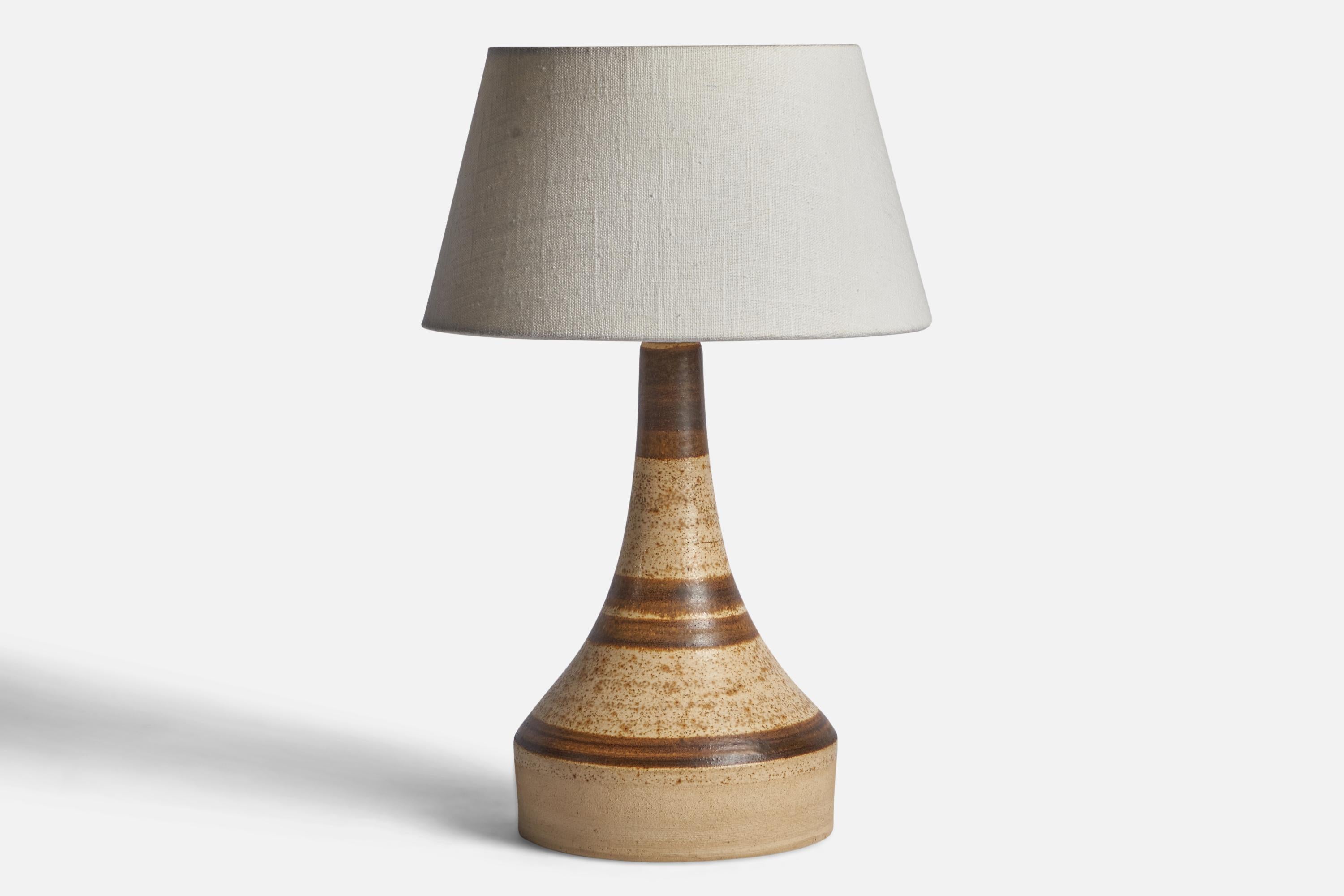 A beige and brown-glazed ceramic table lamp designed and produced in Denmark, c. 1960s.

Dimensions of Lamp (inches): 13” H x 6.3” Diameter
Dimensions of Shade (inches): 7” Top Diameter x 10” Bottom Diameter x 5.5” H 
Dimensions of Lamp with Shade