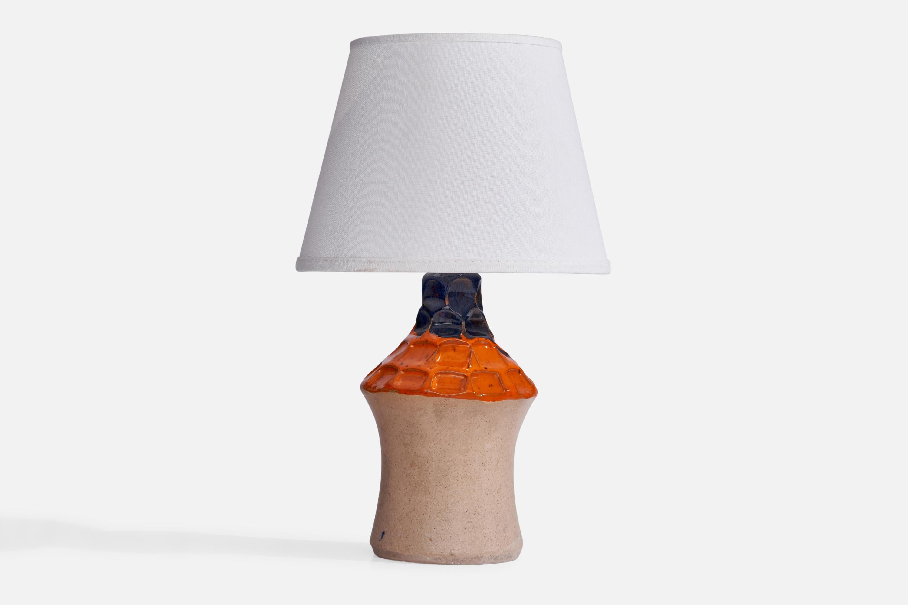 An orange and blue semi-glazed ceramic table lamp designed and produced in Sweden, 1960s.

Dimensions of Lamp (inches): 9.65” H x 4.5” Diameter
Dimensions of Shade (inches): 5.25” Top Diameter x 8” Bottom Diameter x 6” H
Dimensions of Lamp with