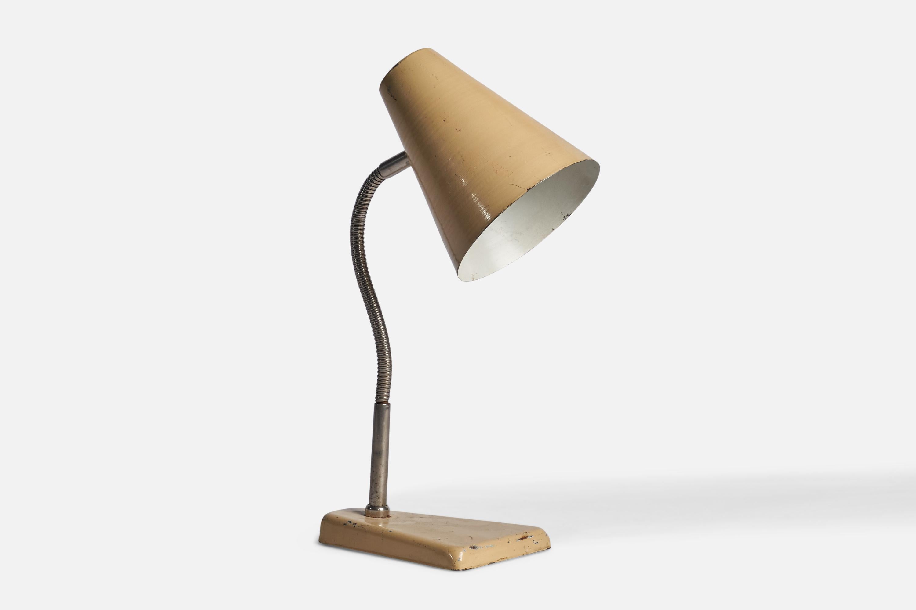 An adjustable chrome and beige-lacquered aluminium table lamp designed and produced in Denmark, 1930s.

Overall Dimensions (inches): 17.5” H x 5.80” W x 9” D
Dimensions variable based on position of light.
Bulb Specifications: E-26 Bulb
Number of