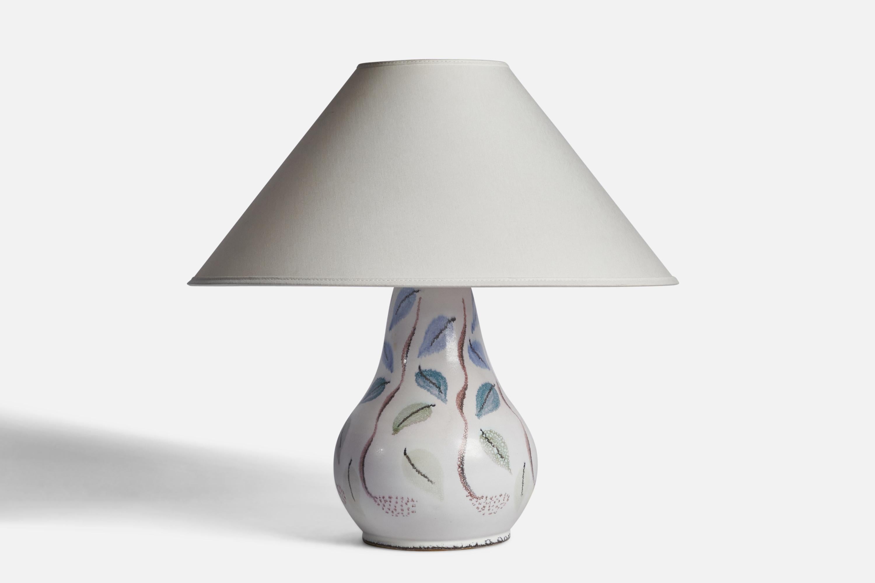A white green blue and brown-painted porcelain table lamp designed and produced in Denmark, 1950s.

Dimensions of Lamp (inches): 11 H x 6.75” Diameter
Dimensions of Shade (inches): 4.5” Top Diameter x 16” Bottom Diameter x 7.25” H
Dimensions of Lamp
