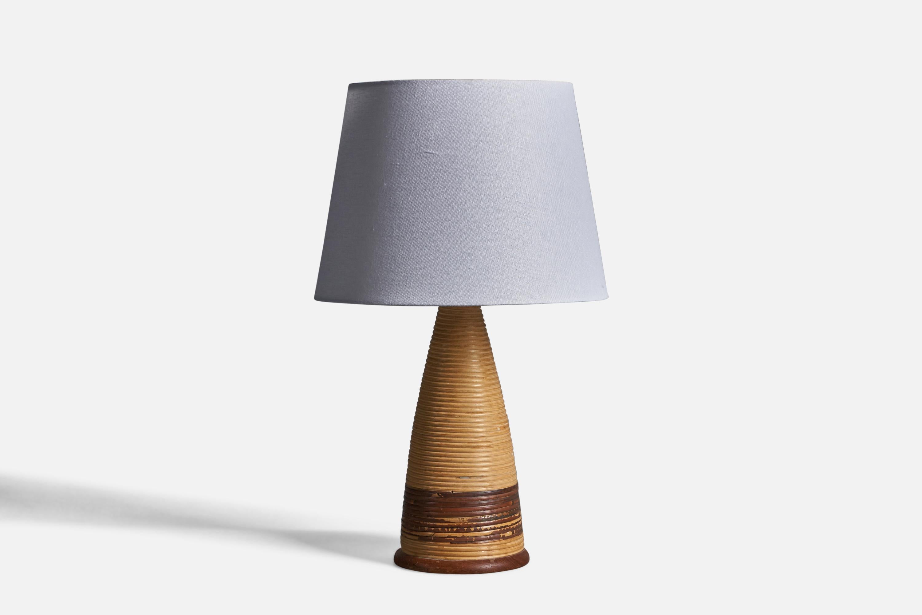 A rattan and teak table lamp, designed and produced in Denmark, 1950s.

Dimensions of Lamp (inches): 15