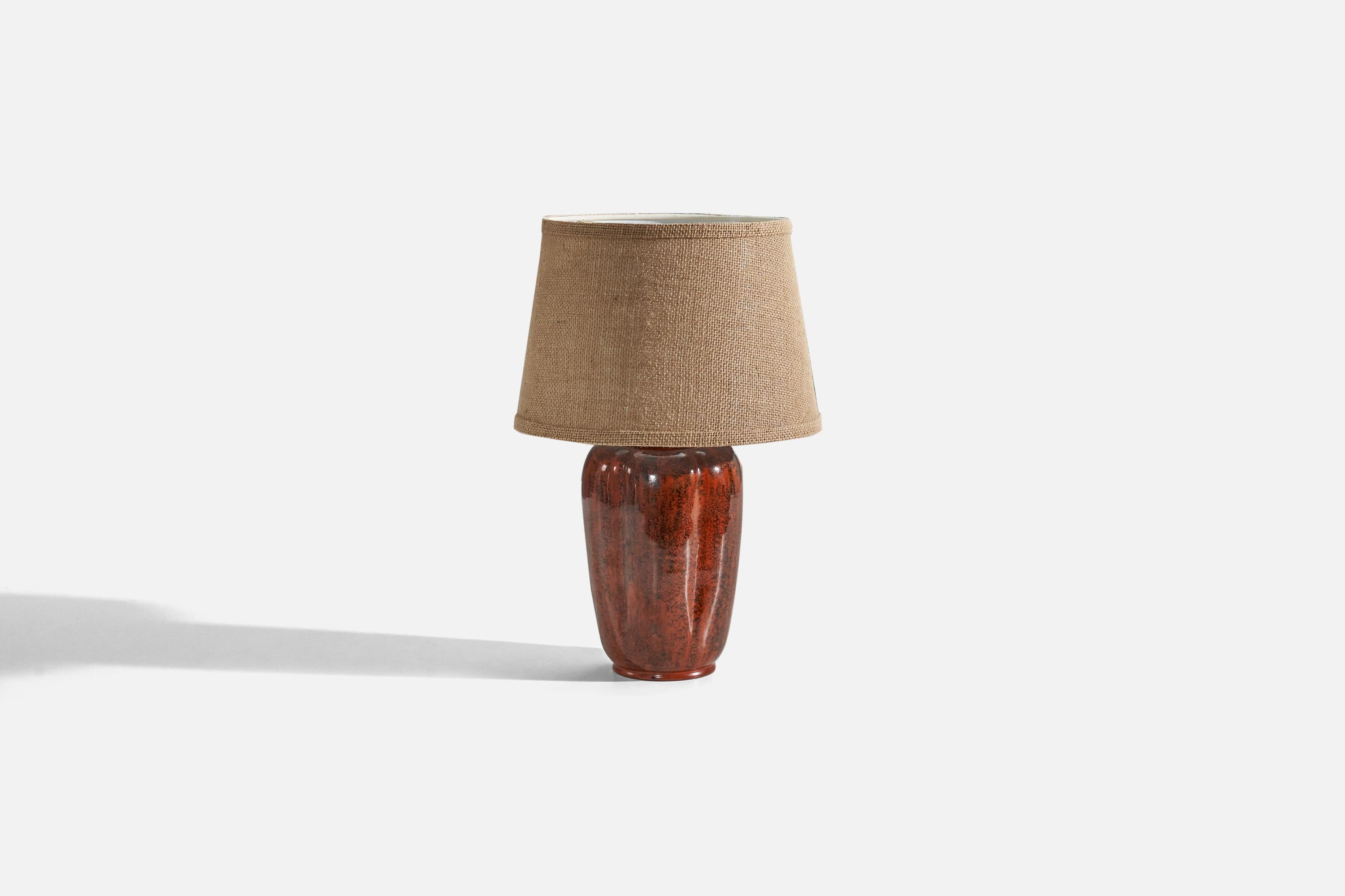 A red and black-glazed ceramic table lamp, designed and produced in Denmark, 1940s.

Sold without lampshade. 
Dimensions of Lamp (inches) : 11.87 x 5.5 x 5.5 (H x W x D)
Dimensions of Shade (inches) : 8 x 10 x 7 (T x B x S)
Dimension of Lamp