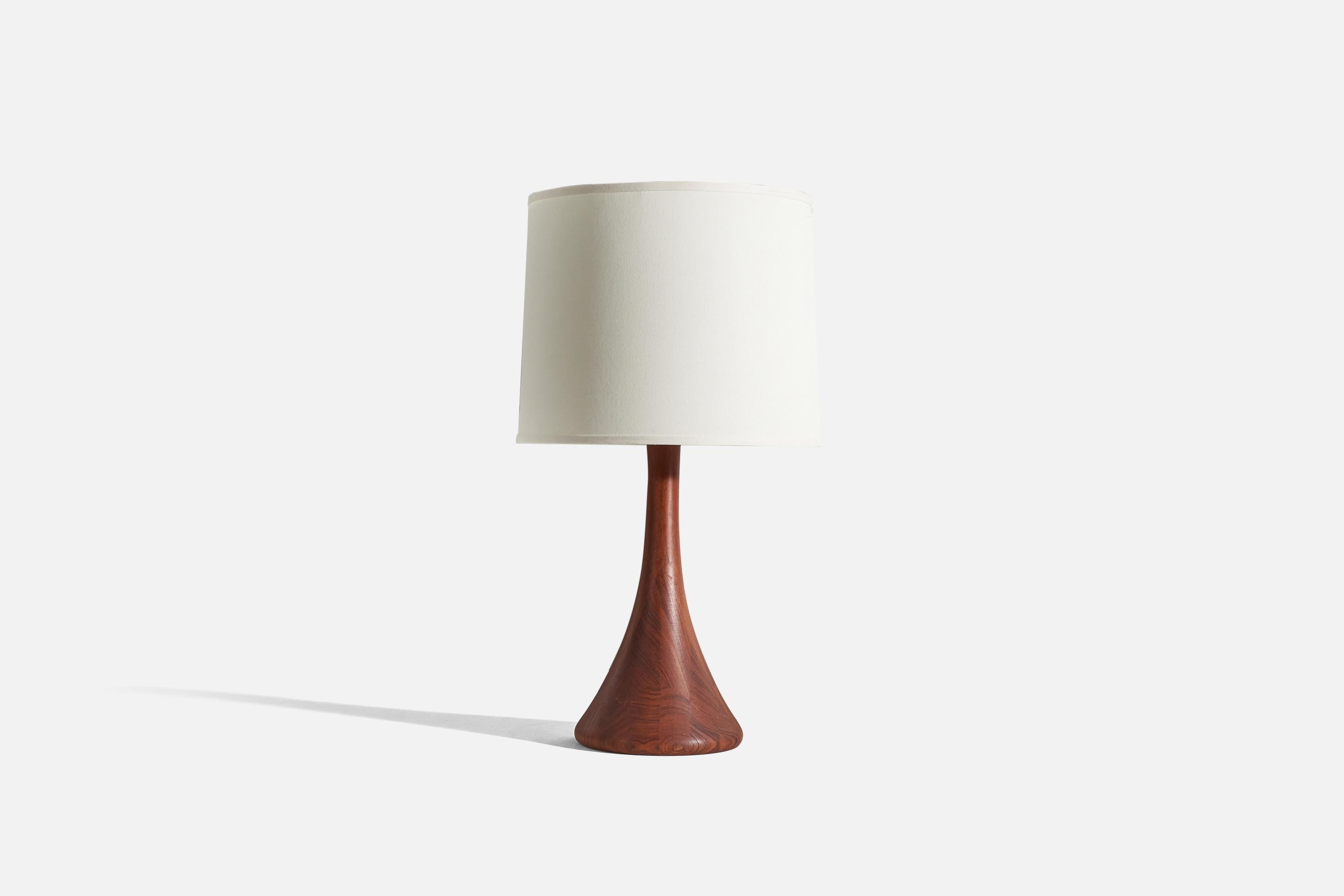 A solid teak table lamp designed and produced in Denmark, 1950s.

Sold without lampshade. 
Dimensions of lamp (inches) : 25.12 x 9.12 x 9.12 (H x W x D)
Dimensions of shade (inches) : 15 x 16.25 x 13 (T x B x S)
Dimension of lamp with shade
