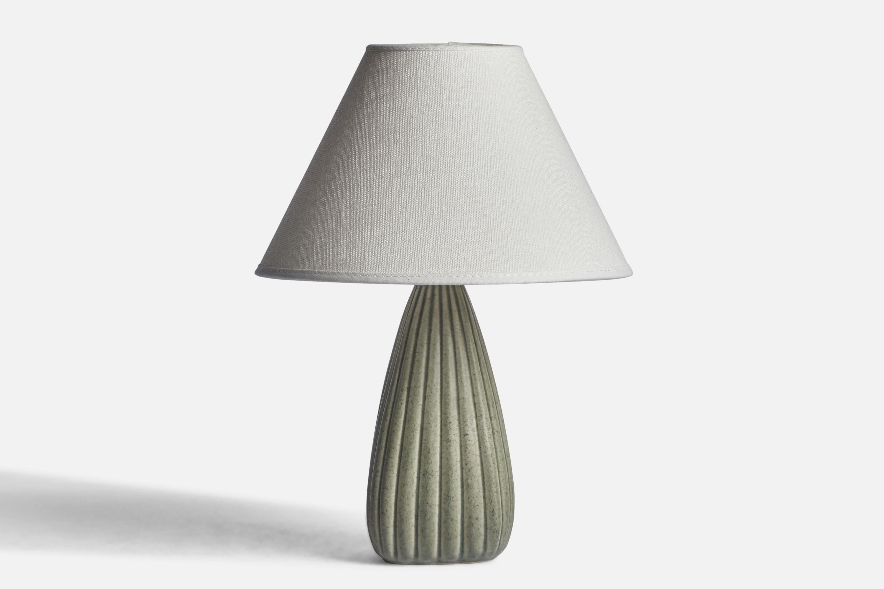 A grey-glazed fluted stoneware table lamp designed and produced in Denmark, c. 1950s.

Dimensions of Lamp (inches): 8” H x 3.2” Diameter
Dimensions of Shade (inches): 3” Top Diameter x 8” Bottom Diameter x 5” H 
Dimensions of Lamp with Shade