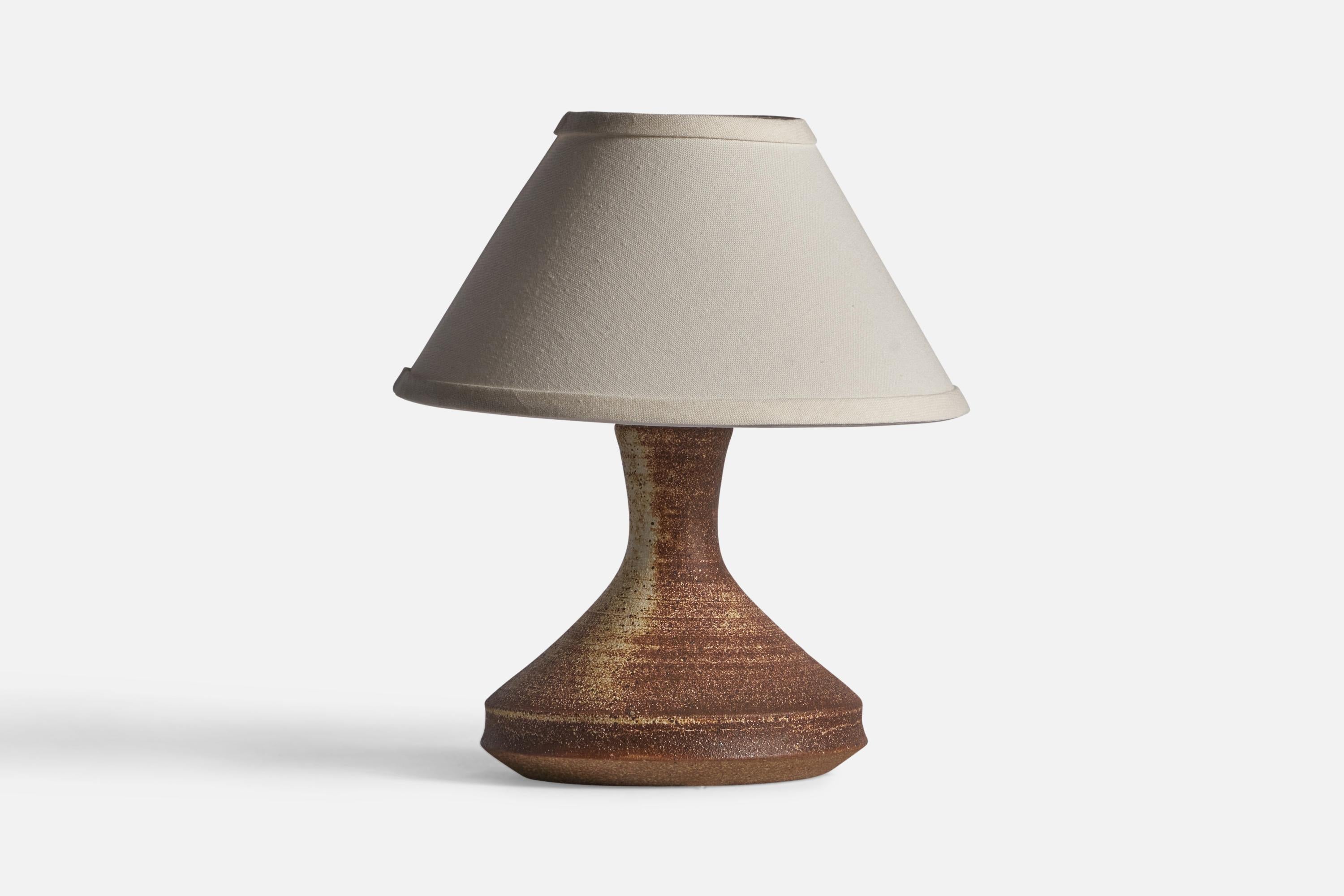 A brown and beige stoneware table lamp, designed and produced in Denmark, c. 1960s.

Dimensions of Lamp (inches): 9.5