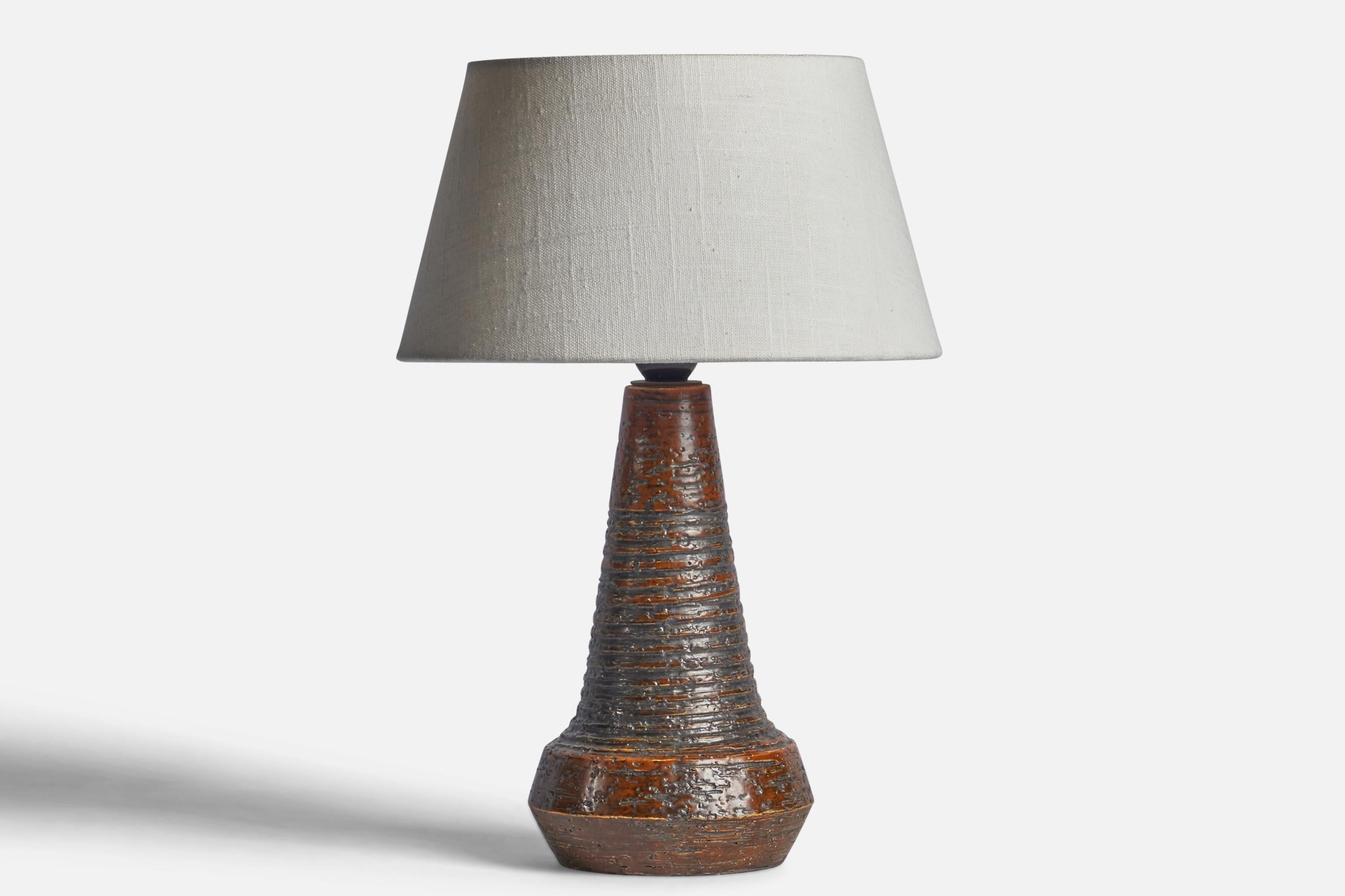 A brown-glazed and incised stoneware table lamp designed and produced in Denmark, 1960s.

Dimensions of Lamp (inches): 12