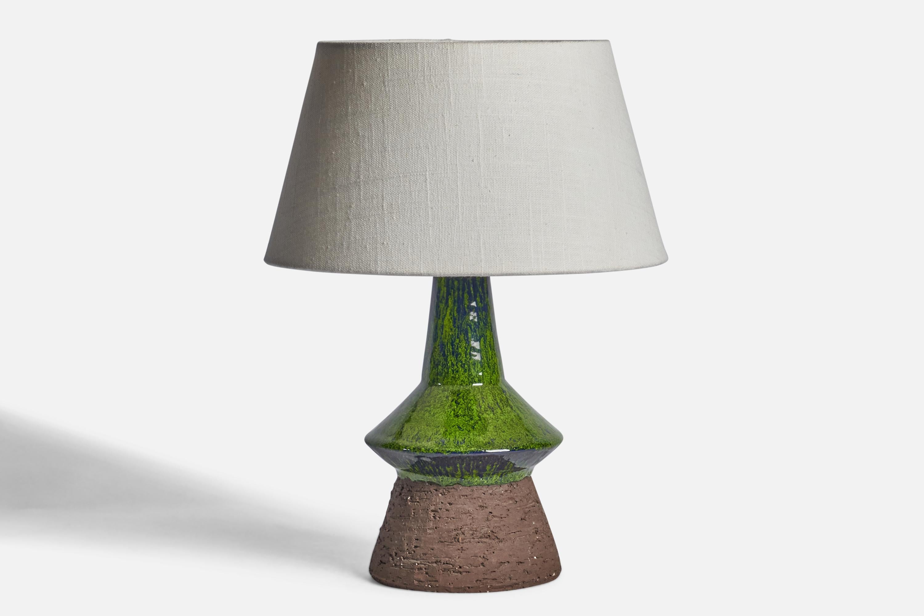 A green semi-glazed stoneware table lamp designed and produced in Denmark, c. 1960s.

Dimensions of Lamp (inches): 10.75” H x 5.25” Diameter
Dimensions of Shade (inches): 7” Top Diameter x 10” Bottom Diameter x 5.5” H 
Dimensions of Lamp with Shade