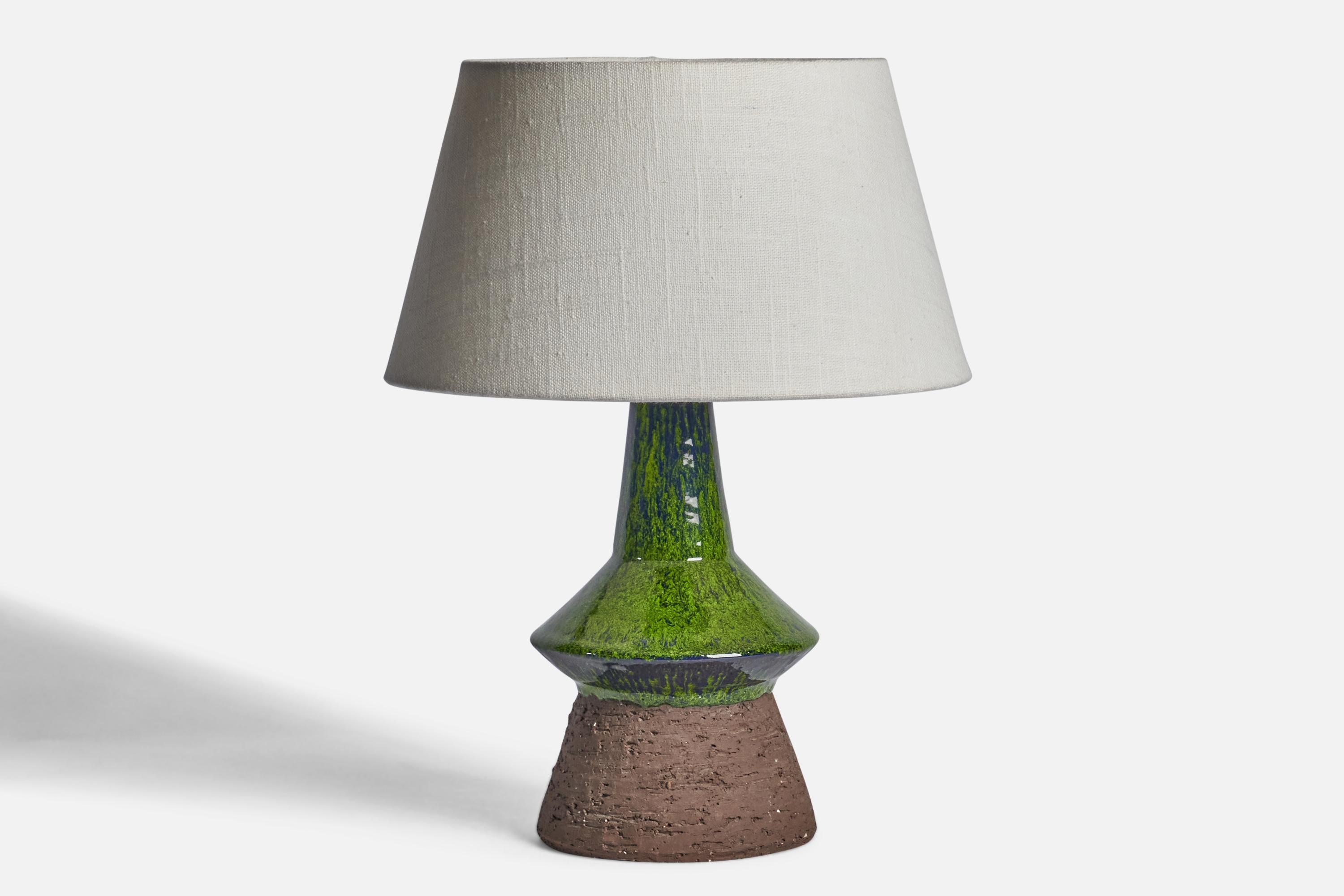 A green semi-glazed stoneware table lamp designed and produced in Denmark, c. 1960s.

Dimensions of Lamp (inches): 10.75” H x 5.25” Diameter
Dimensions of Shade (inches): 7” Top Diameter x 10” Bottom Diameter x 5.5” H 
Dimensions of Lamp with Shade