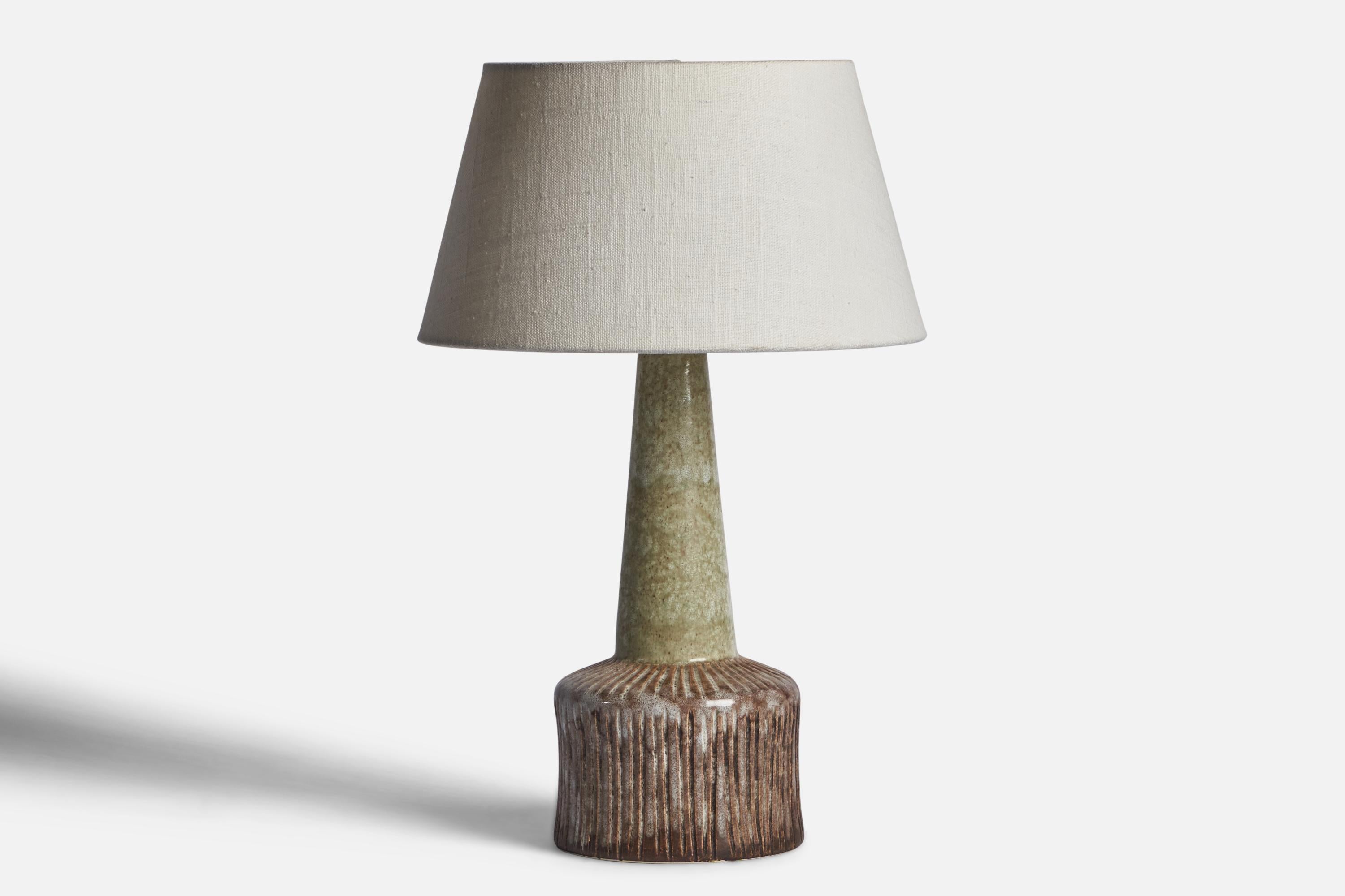A brown and green-glazed stoneware table lamp designed and produced in Denmark, c. 1960s.

Dimensions of Lamp (inches): 12.45” H x 4.85” Diameter
Dimensions of Shade (inches): 7” Top Diameter x 10” Bottom Diameter x 5.5” H 
Dimensions of Lamp with