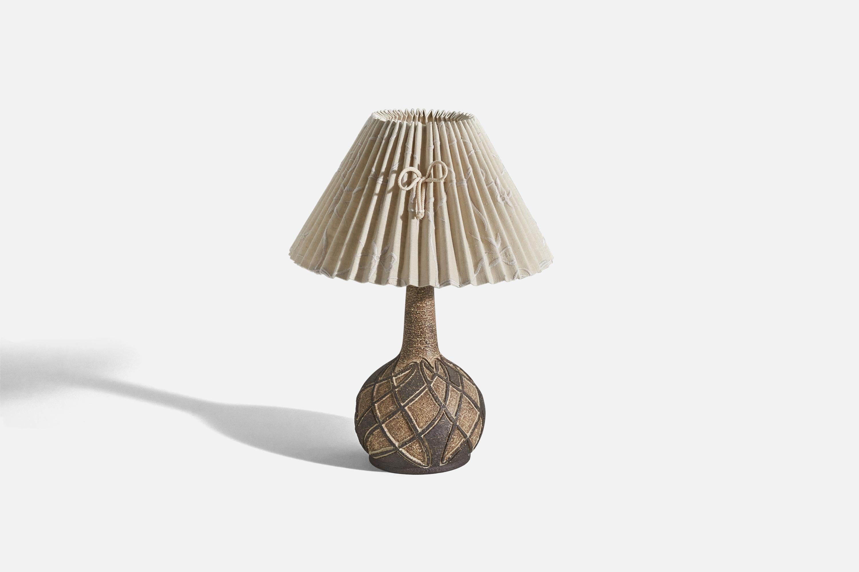 A sizeable brown glazed stoneware and fabric table lamp designed and produced by a Danish designer, Denmark, c. 1960s.

Sold with Lampshade. 
Stated dimensions refer to the Lamp with the Shade. 