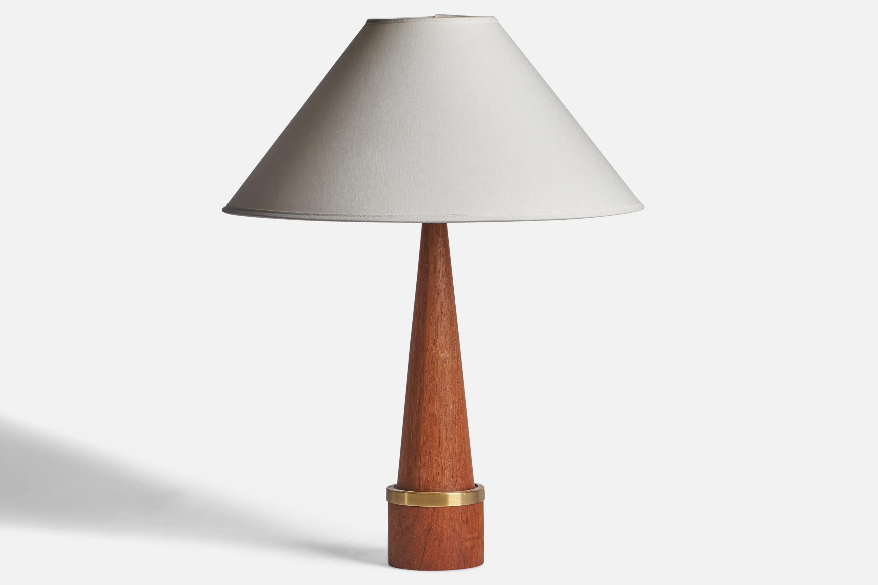 A teak and brass table lamp designed and produced in Denmark, c. 1950s.

Dimensions of Lamp (inches): 16.5” H x 3.8” Diameter
Dimensions of Shade (inches): 4.5” Top Diameter x 16” Bottom Diameter x 7.25” H
Dimensions of Lamp with Shade (inches):