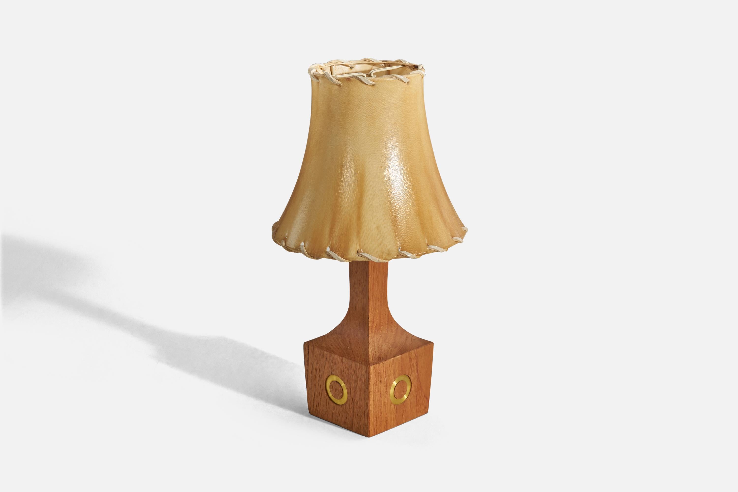 A teak, brass and leather table lamp designed and produced in Denmark, 1950s.

Sold with lampshade. 
Dimensions of lamp (inches) : 10.06 x 3.52 x 3.52 (height x width x depth)
Dimensions of shade (inches) : 4.12 x 7.25 x 6.37 (top diameter x